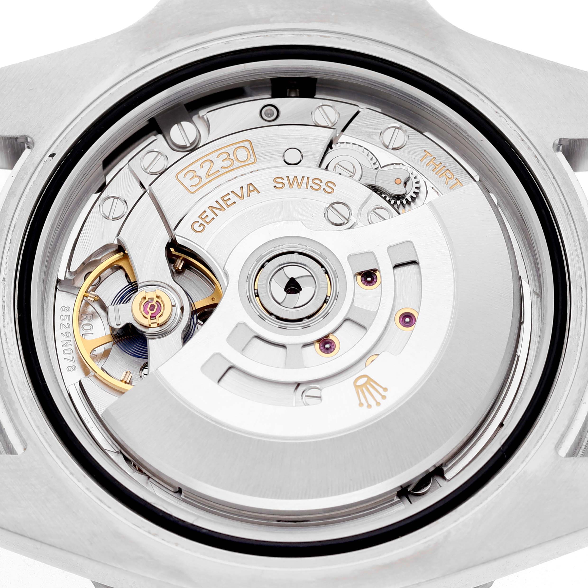The image shows the back view of a Rolex Submariner M124060-0001 Men's Stainless Steel Black Dial watch, displaying its intricate movement mechanism.