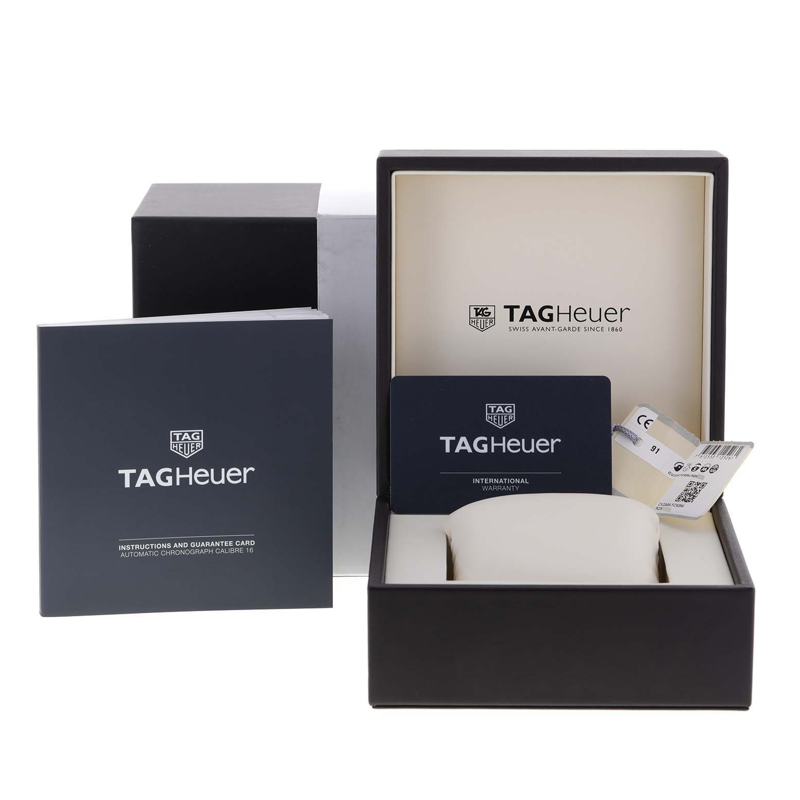 The image shows the box and accessories for a Tag Heuer Carrera CV2A84.FC6394 Men's Titanium Black Dial CV2A84.FC6394 Men's Titanium Black Dial watch, including the warranty card and instruction manual.