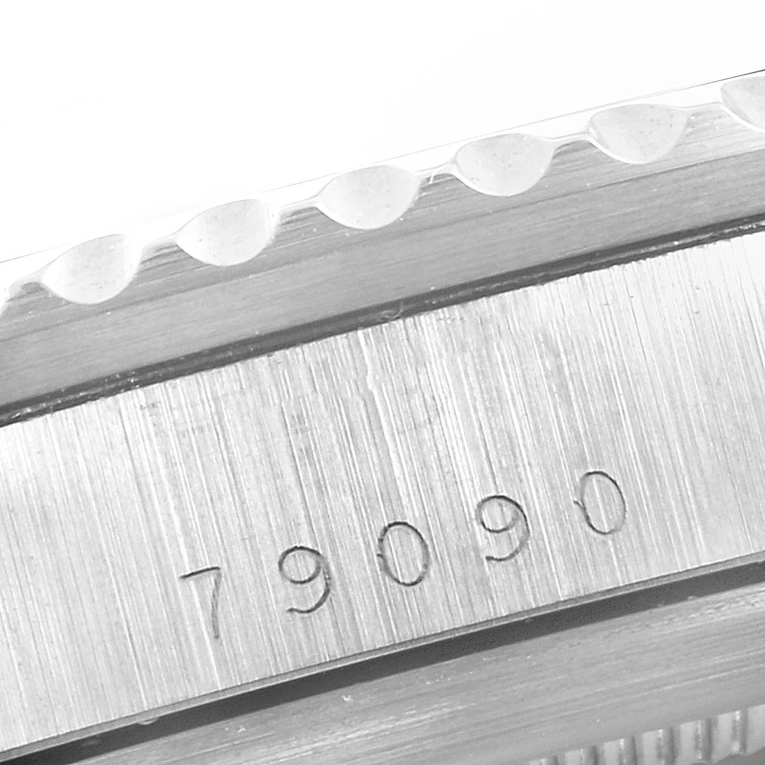 This image shows a close-up angle of the bezel and model number engraving on a Tudor Submariner 79090 Men's Stainless Steel Black Dial 79090 Men's Stainless Steel Black Dial watch.