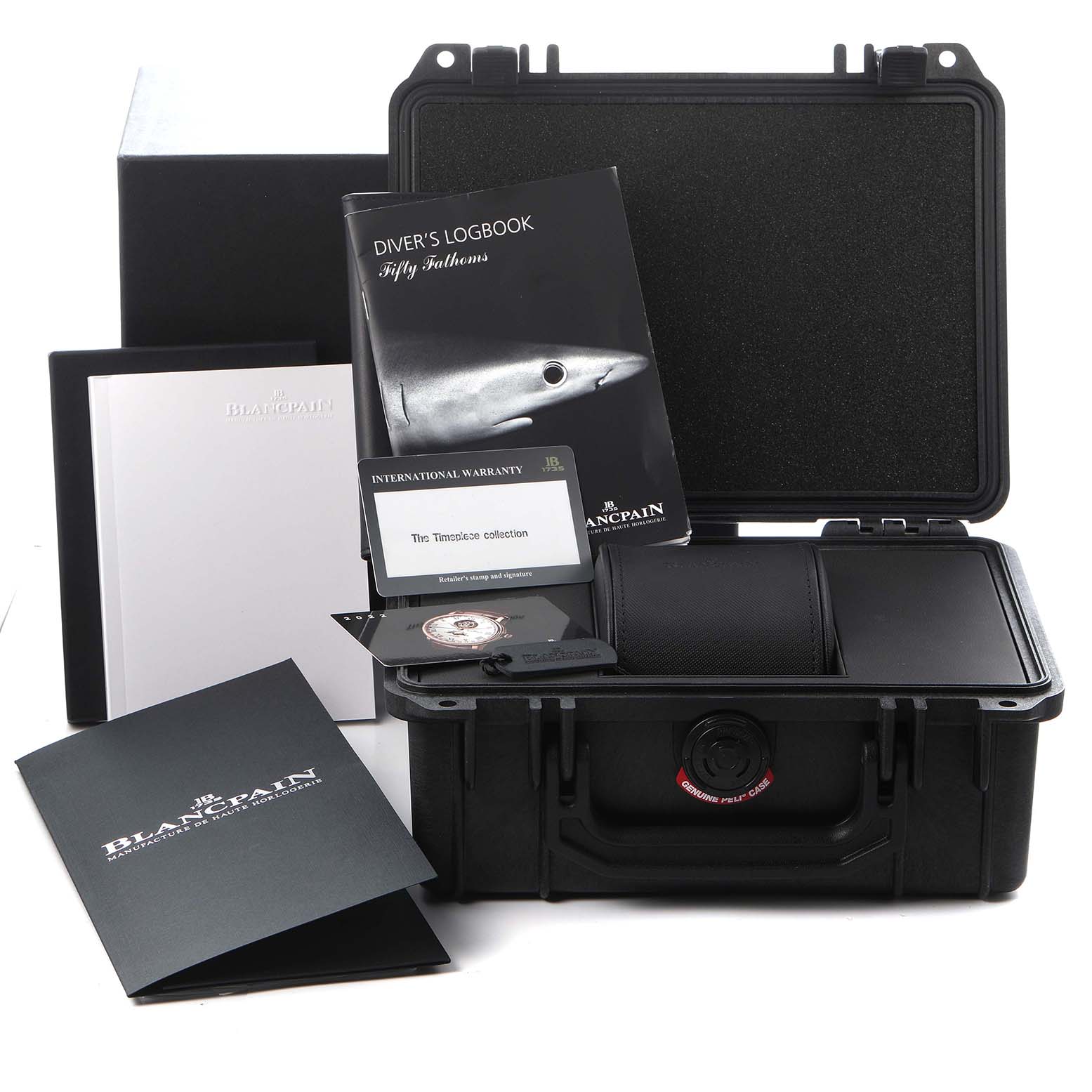 The image shows the accessories for the Blancpain Fifty Fathoms model 5015-1130-715, including a carrying case, logbook, warranty card, and documents.