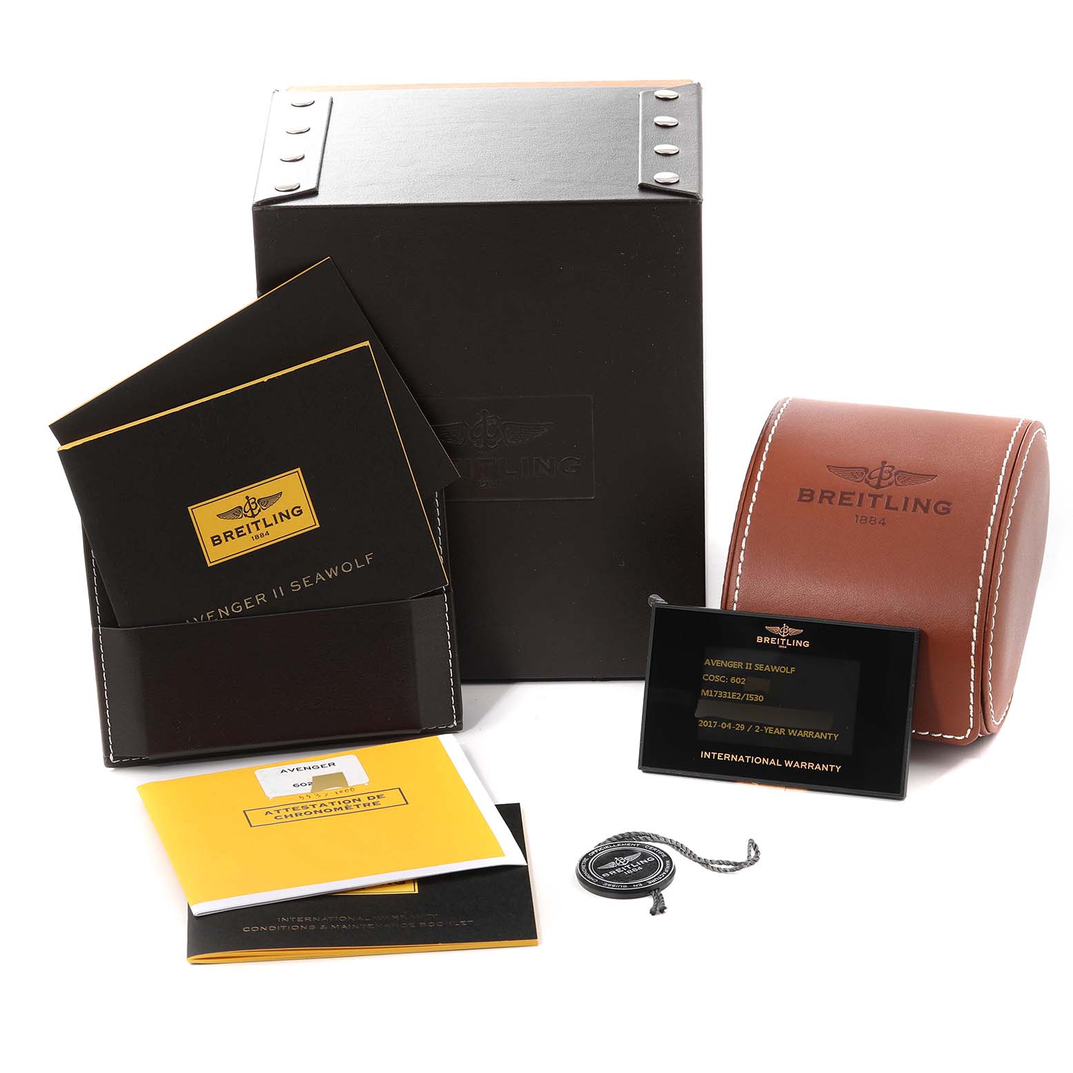 The image shows packaging and accessories for the Breitling Avenger M17331 Men's Stainless Steel Yellow Dial M17331 Men's Stainless Steel Yellow Dial model, including a box, leather case, warranty card, and manuals.