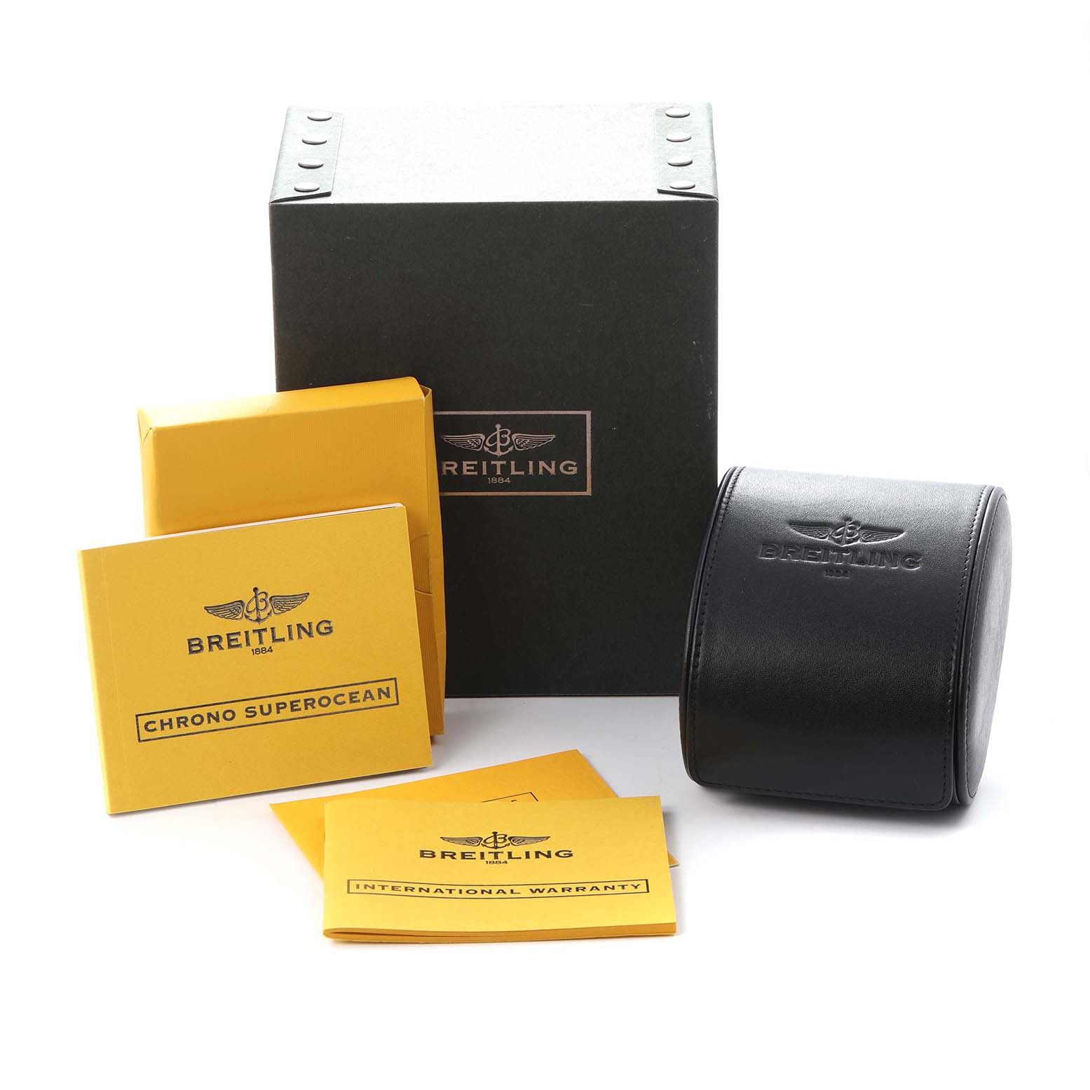 The image shows the packaging and accessories for a Breitling Superocean watch, model A13340, including a box, warranty, and manuals.