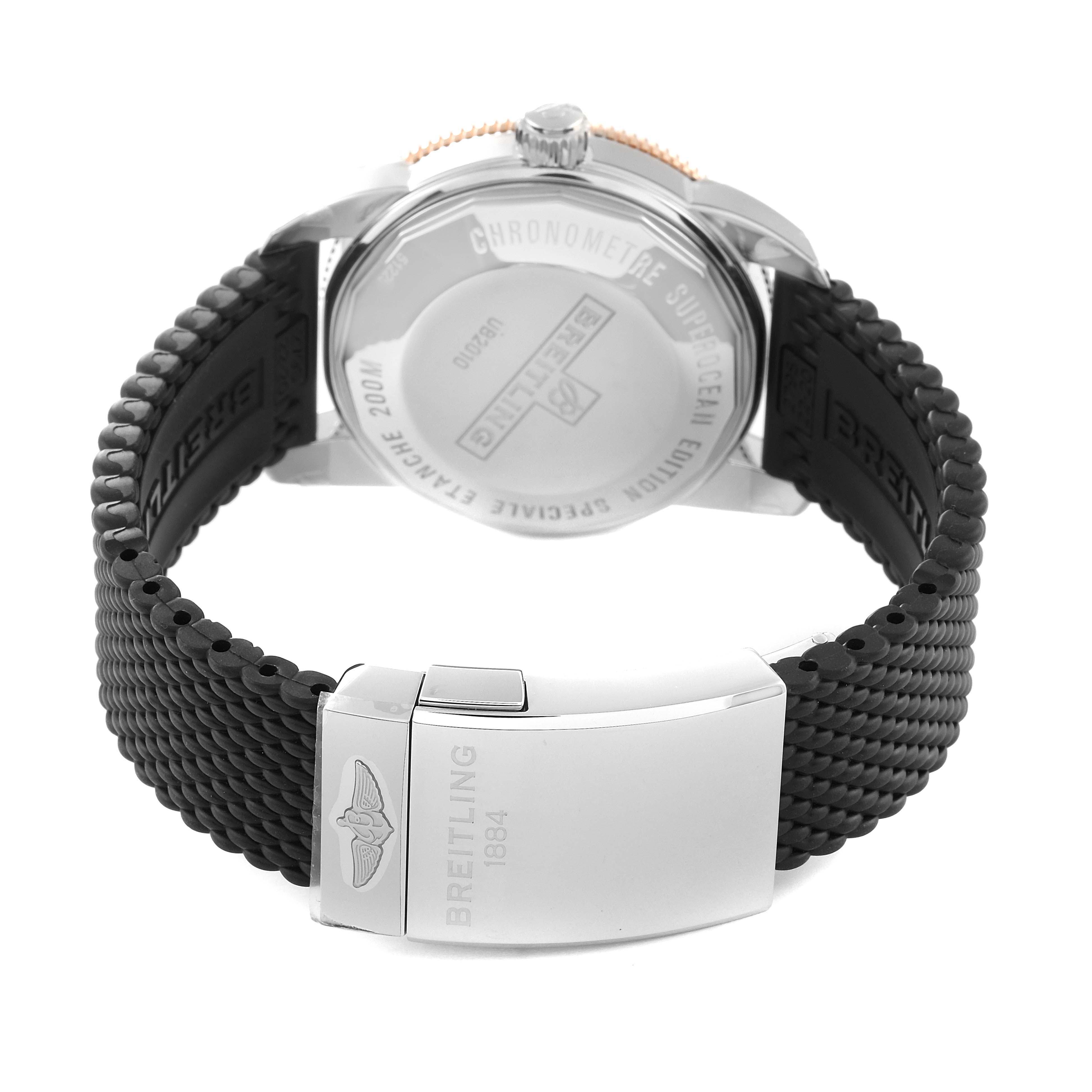 The image shows the back case and black strap of a Breitling Superocean UB2010 Men's Steel and Gold (two tone) Black Dial UB2010 Men's Steel and Gold (two tone) Black Dial watch, highlighting its clasp and engravings.