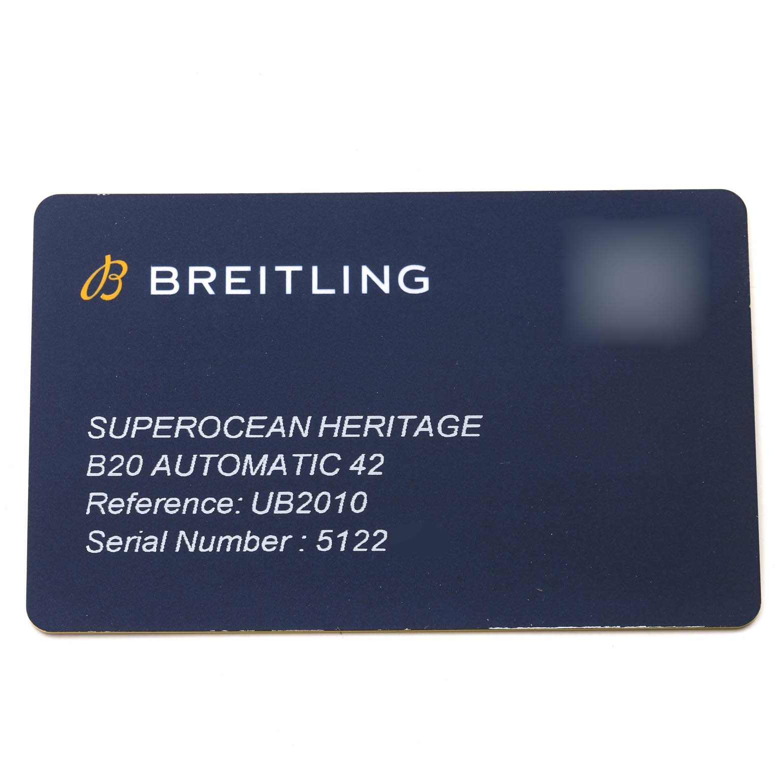 This is a warranty card for the Breitling Superocean UB2010 Men's Steel and Gold (two tone) Black Dial UB2010 Men's Steel and Gold (two tone) Black Dial Heritage B20 Automatic 42 watch, showing its reference and serial number.
