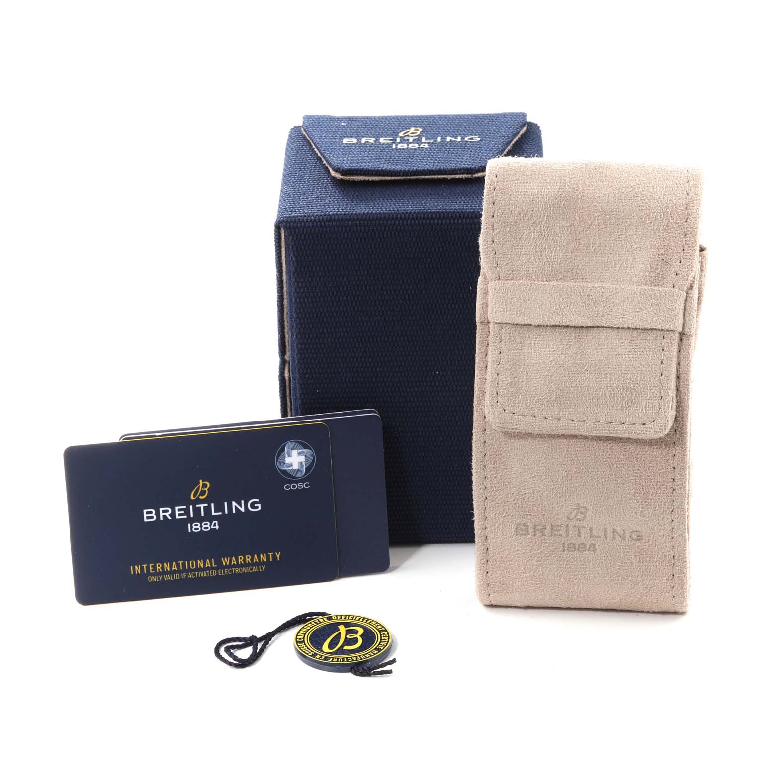 The image shows the Superocean model by Breitling's accessories including a box, pouch, warranty card, and tag.