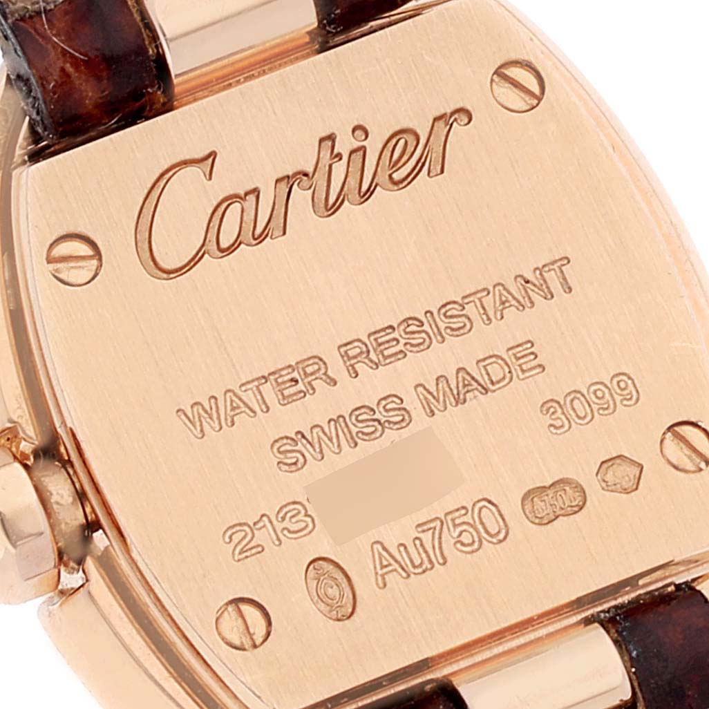 This image shows the back case of a Cartier Baignoire WB520028 Women
s Rose Gold Silver Dial WB520028 Women
s Rose Gold Silver Dial watch, highlighting its inscriptions and the leather strap attachment.