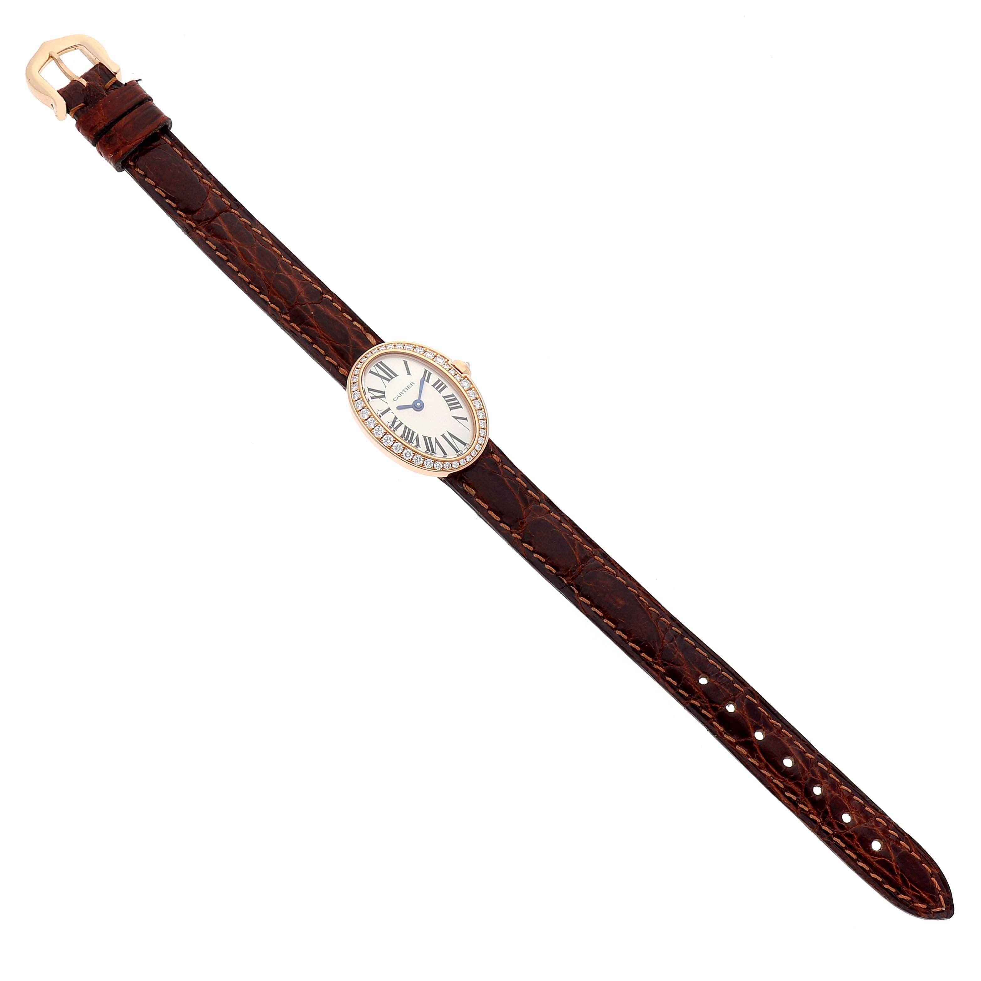The Cartier Baignoire WB520028 Women
s Rose Gold Silver Dial WB520028 Women
s Rose Gold Silver Dial watch is shown from a top-down angle, displaying the full watch and brown leather strap.