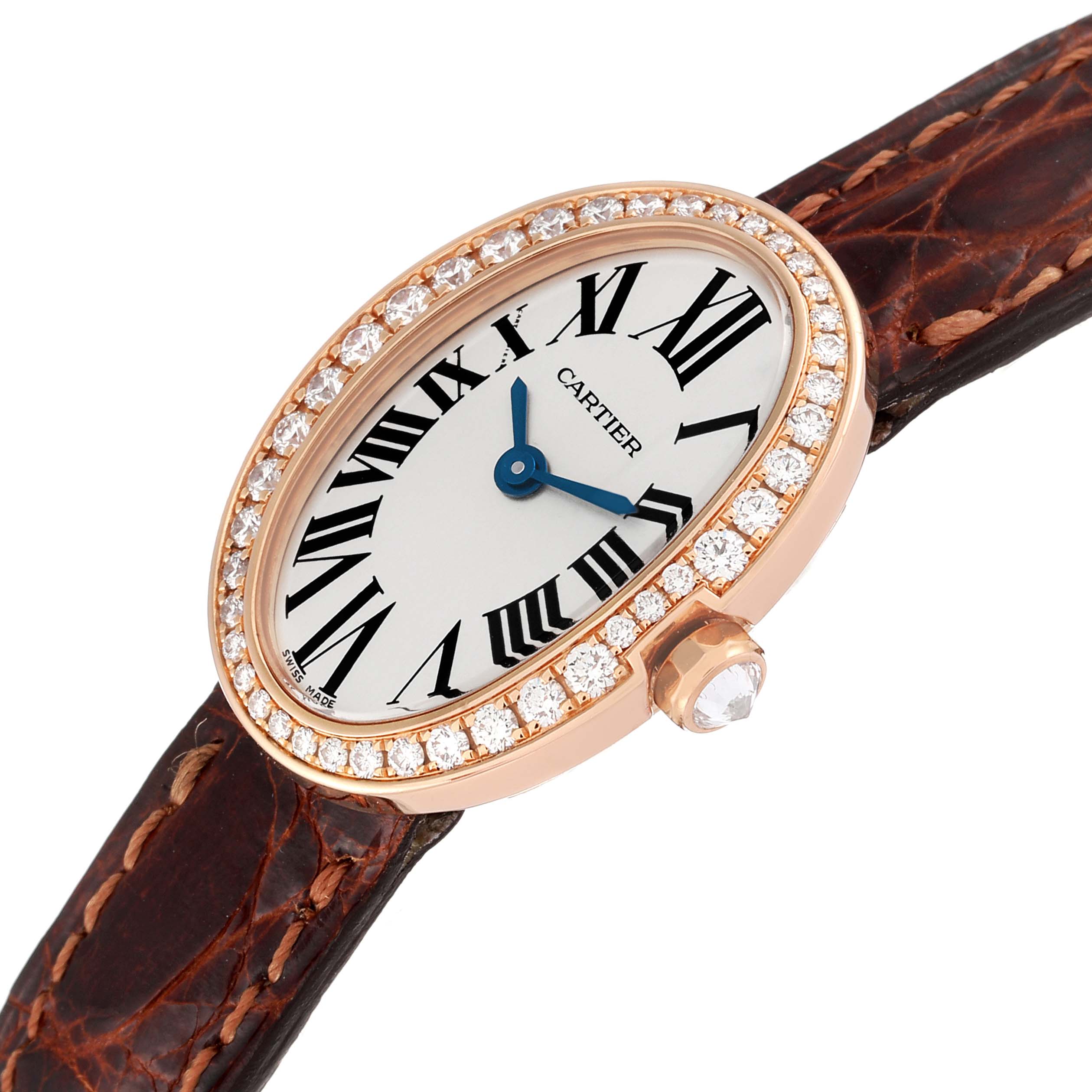 The image shows a Cartier Baignoire WB520028 Women
s Rose Gold Silver Dial WB520028 Women
s Rose Gold Silver Dial watch from an angled top view, displaying its diamond-encrusted bezel and brown leather strap.