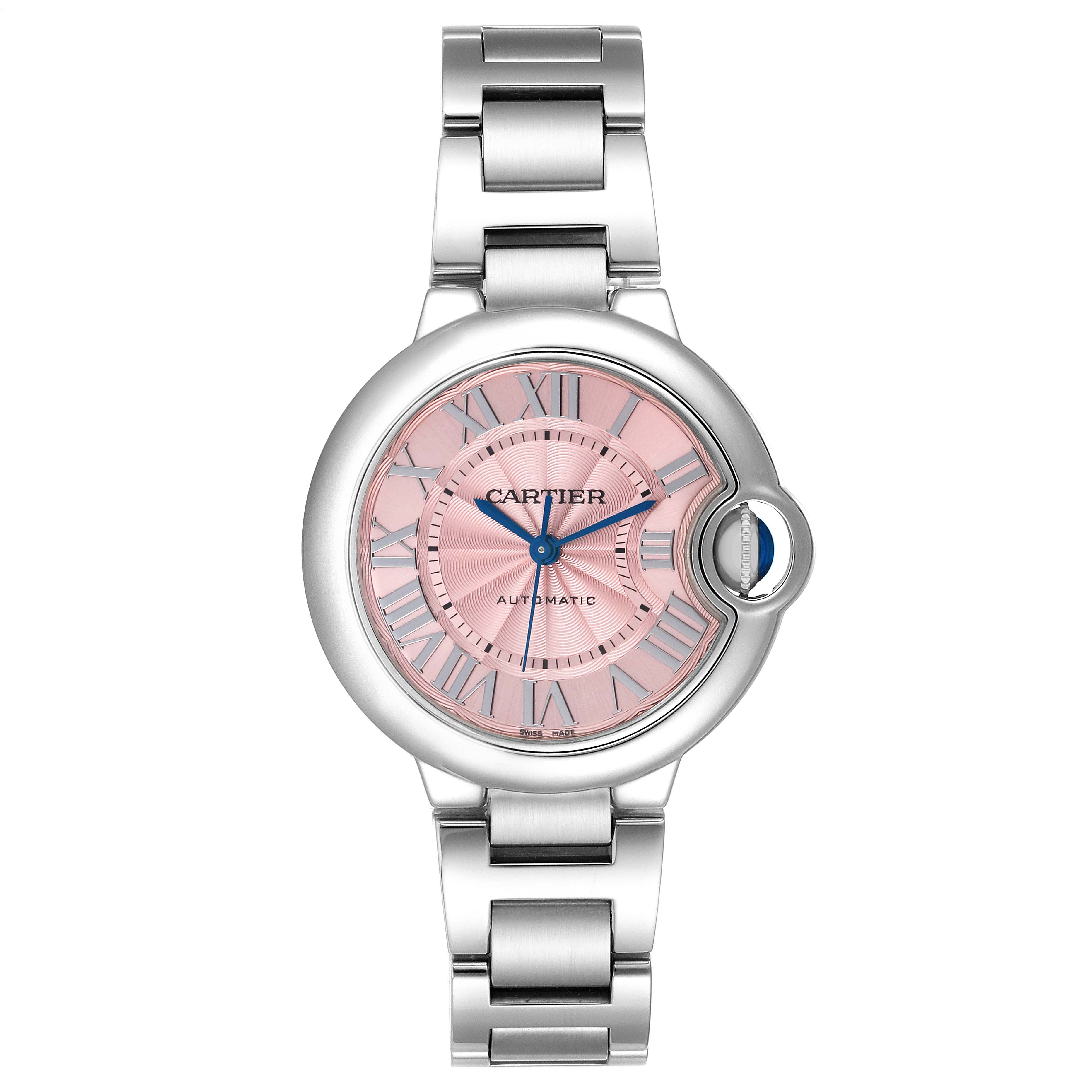 The image shows a top-down view of the Cartier Ballon Bleu W6920100 Women
s Stainless Steel Pink Dial W6920100 Women
s Stainless Steel Pink Dial watch, highlighting its pink dial, blue hands, and metal bracelet.