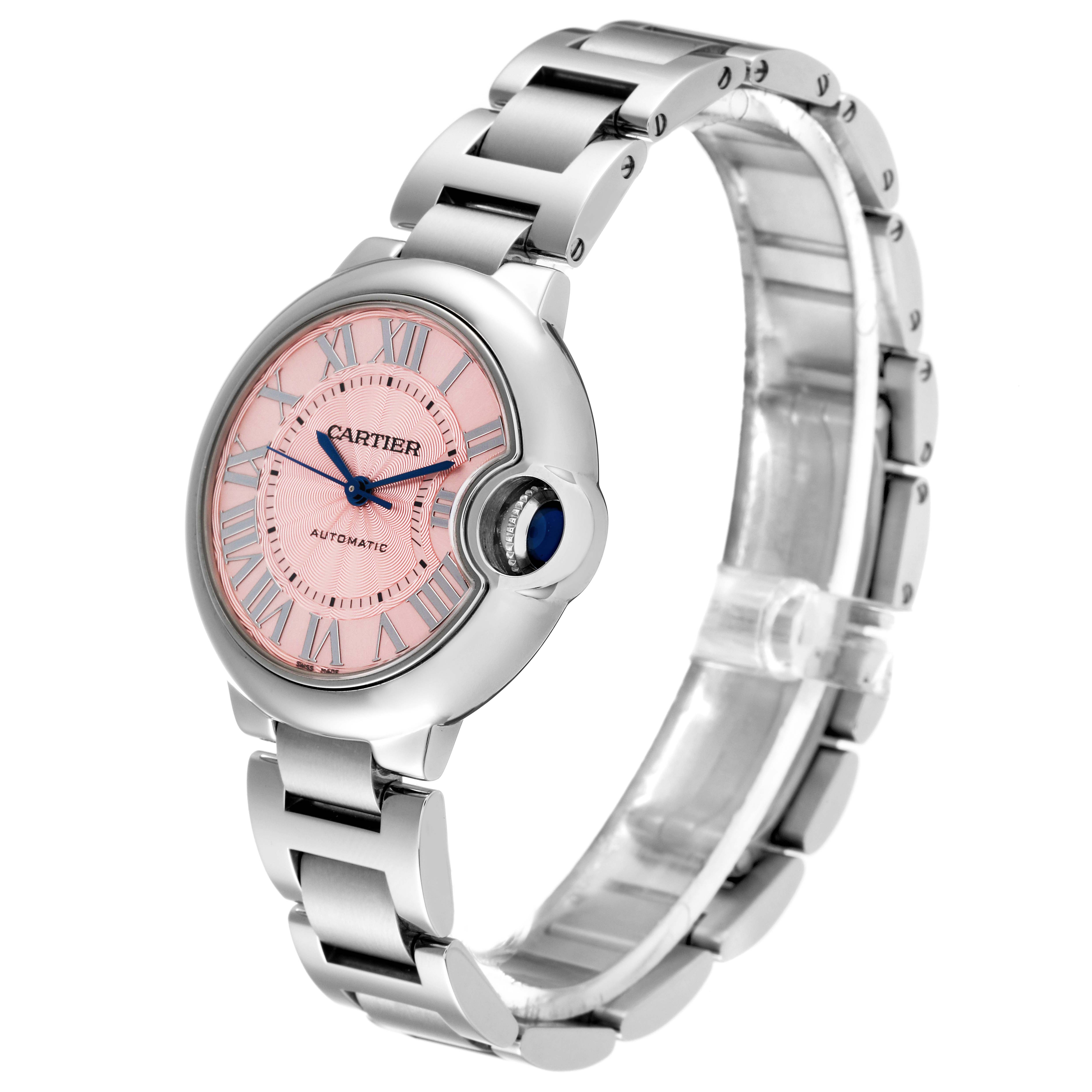The image shows a Cartier Ballon Bleu W6920100 Women
s Stainless Steel Pink Dial W6920100 Women
s Stainless Steel Pink Dial watch at a side angle, highlighting its pink dial, steel bracelet, and signature blue sapphire crown.