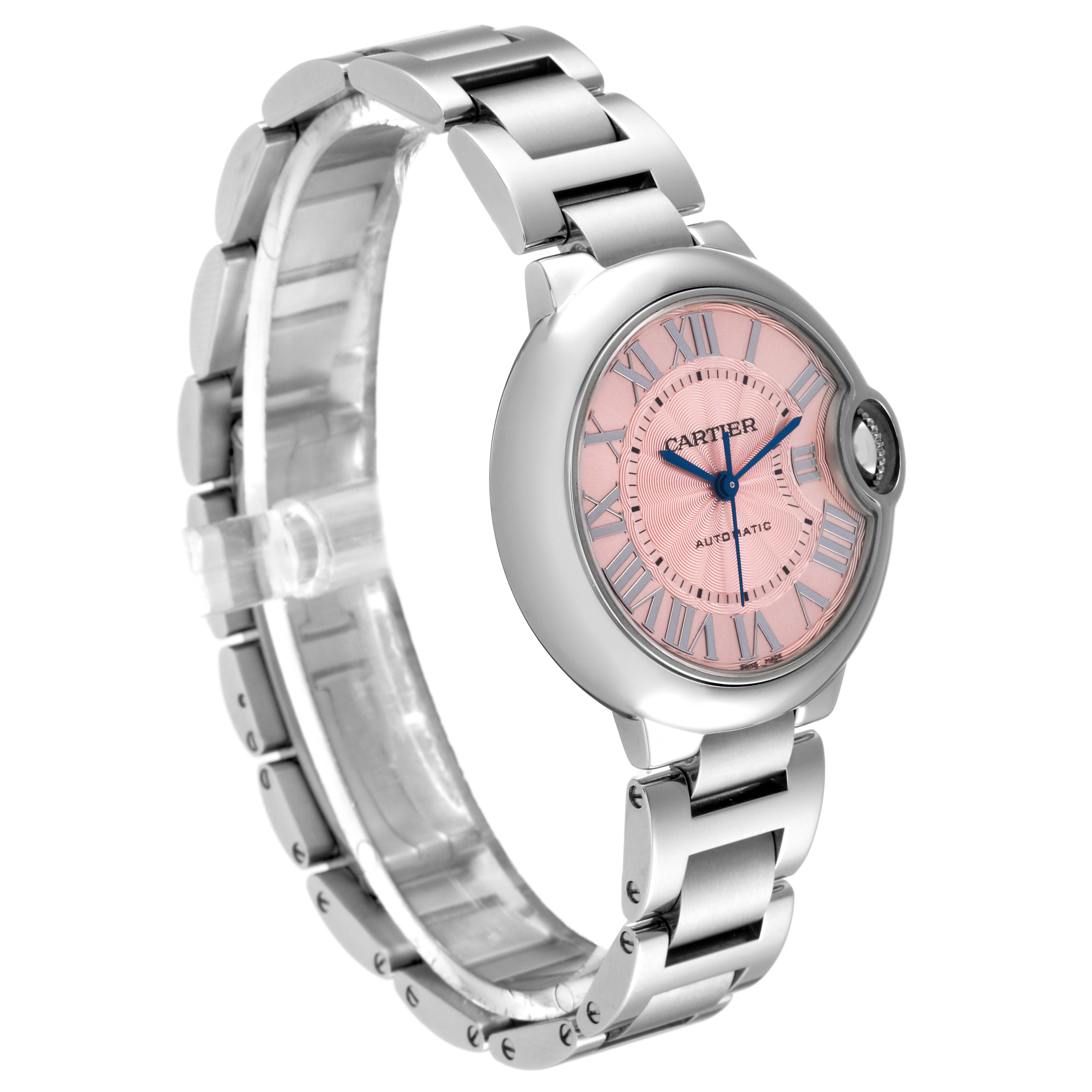 The Cartier Ballon Bleu W6920100 Women
s Stainless Steel Pink Dial W6920100 Women
s Stainless Steel Pink Dial watch is shown at an angled front view, revealing its pink dial, Roman numerals, and metal bracelet.