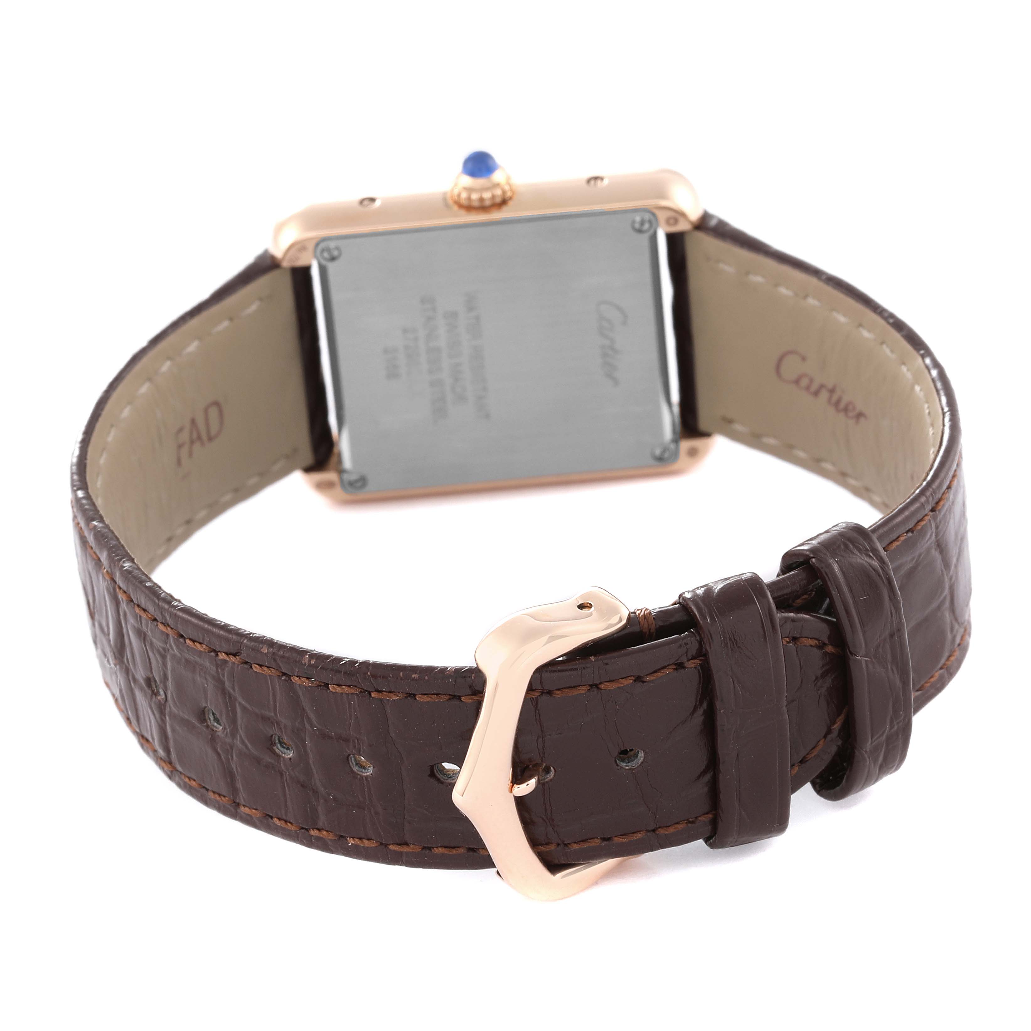 This image shows the back view of a Cartier Tank Solo W5200024 Women
s Steel and Gold (two tone) Silver Dial W5200024 Women
s Steel and Gold (two tone) Silver Dial watch, including the case back, crown, and brown leather strap with a buckle.