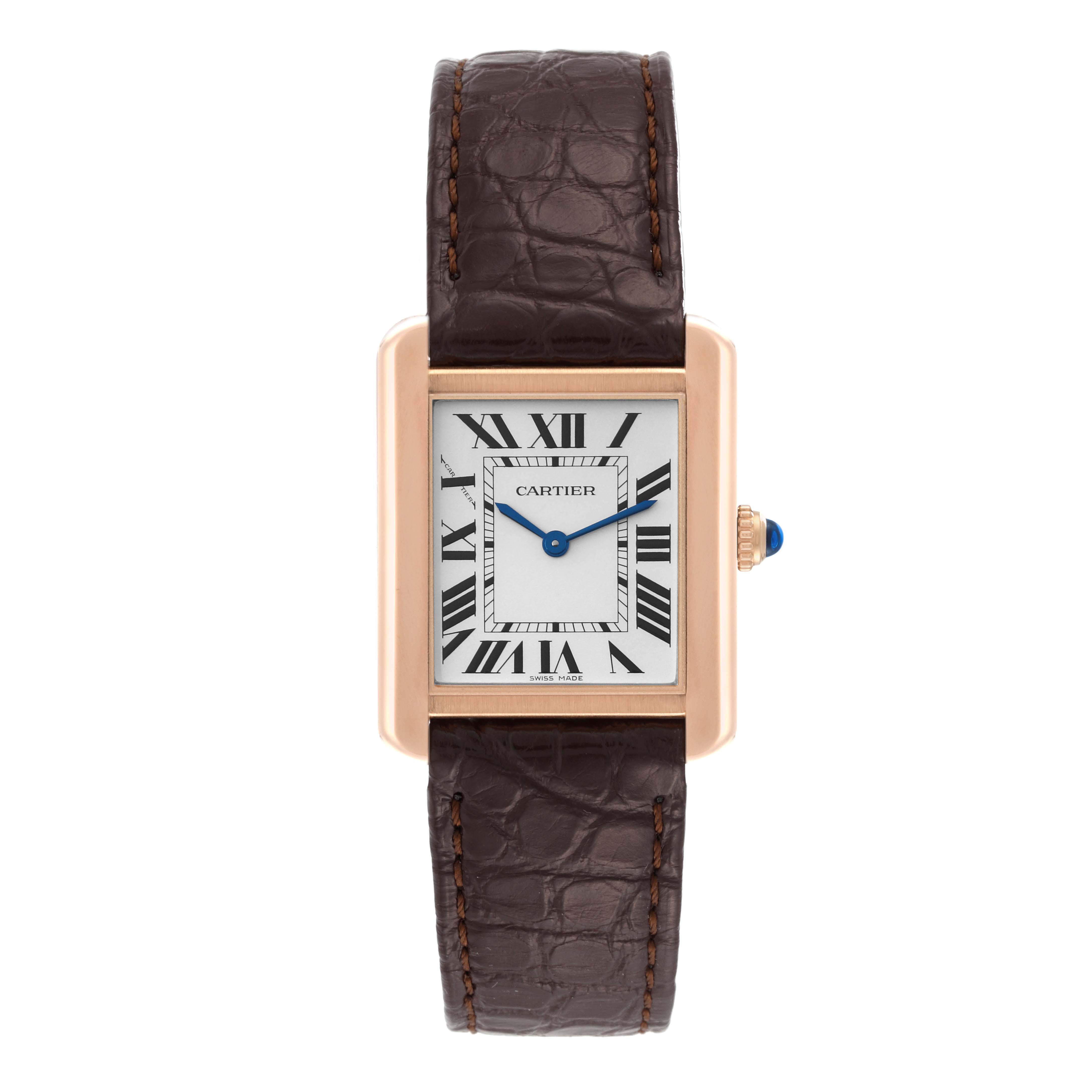 The image shows a frontal view of a Tank Solo model by Cartier, featuring a brown leather strap and a rectangular gold case with Roman numerals.