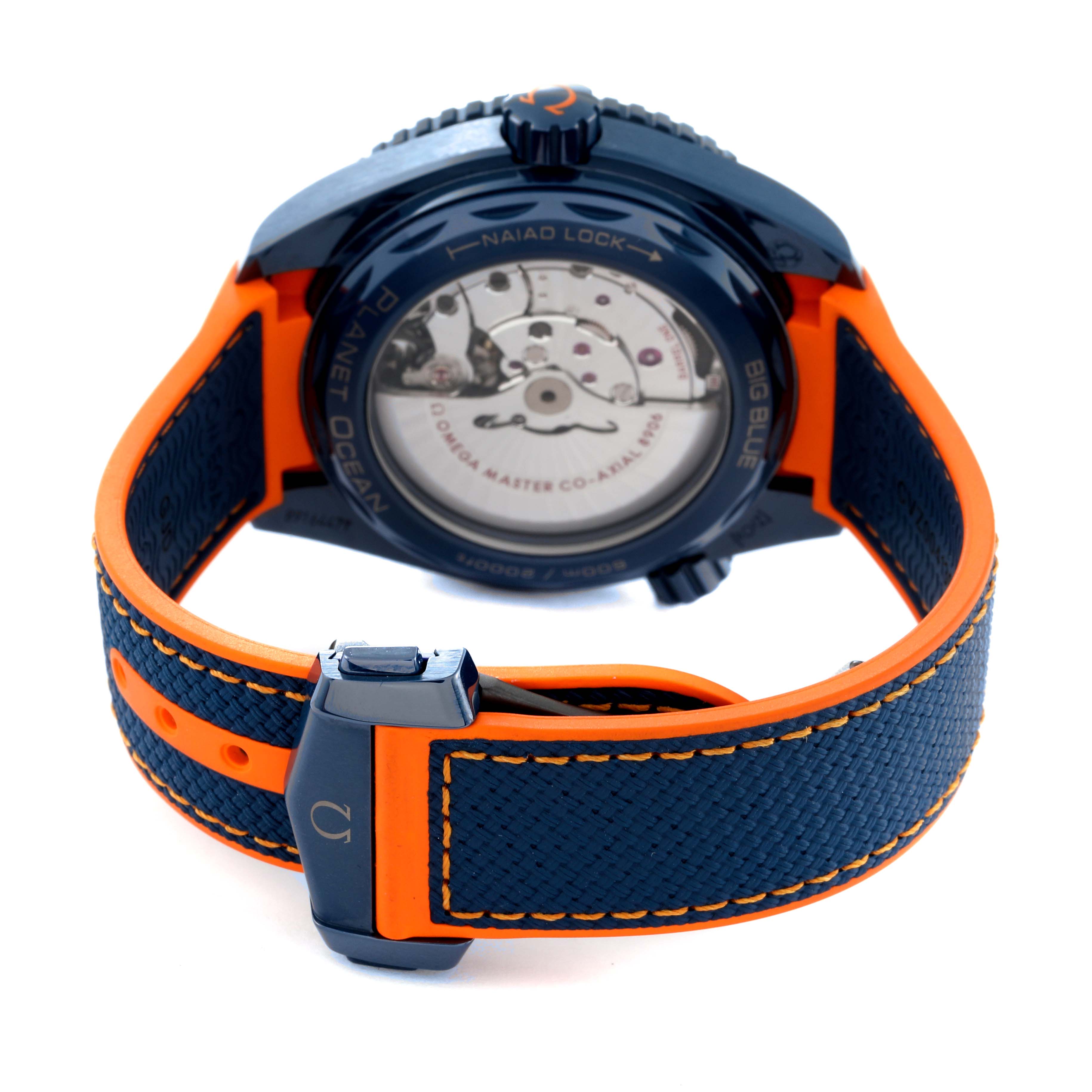 This image shows the back view of an Omega Planet Ocean 215.92.46.22.03.001 Men's Ceramic Blue Dial 215.92.46.22.03.001 Men's Ceramic Blue Dial watch, highlighting the movement and orange and blue strap.
