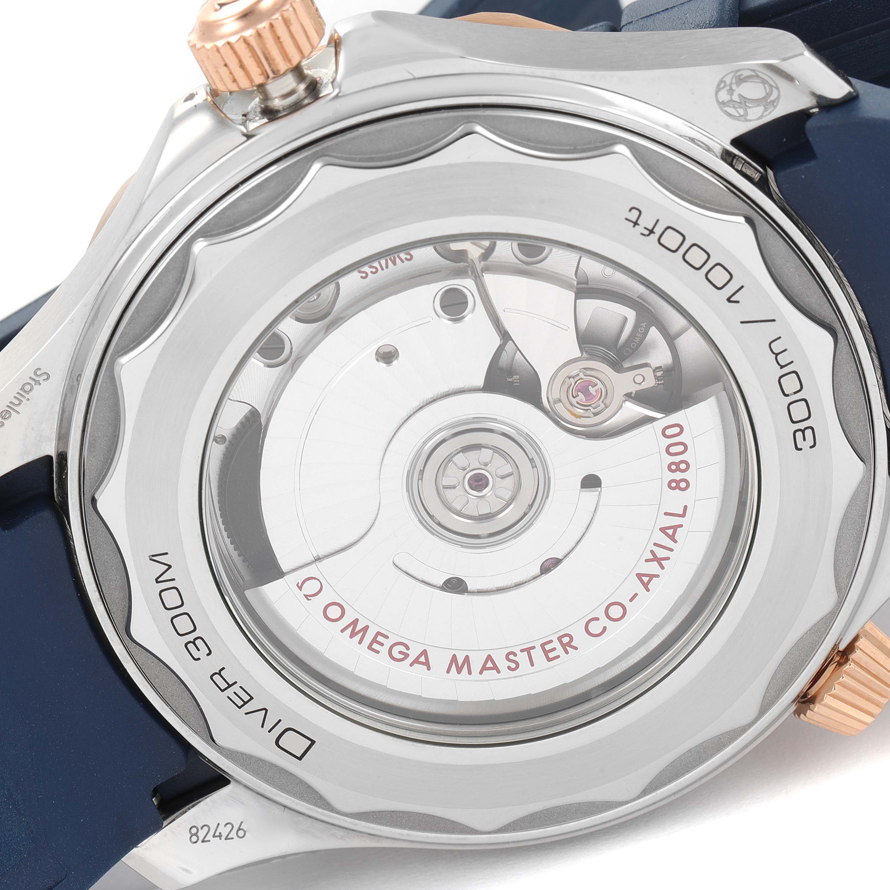 The image shows the case back of an Omega Seamaster 210.22.42.20.03.002 Men's Steel and Gold (two tone) Blue Dial 210.22.42.20.03.002 Men's Steel and Gold (two tone) Blue Dial watch, highlighting its movement and transparent case back.