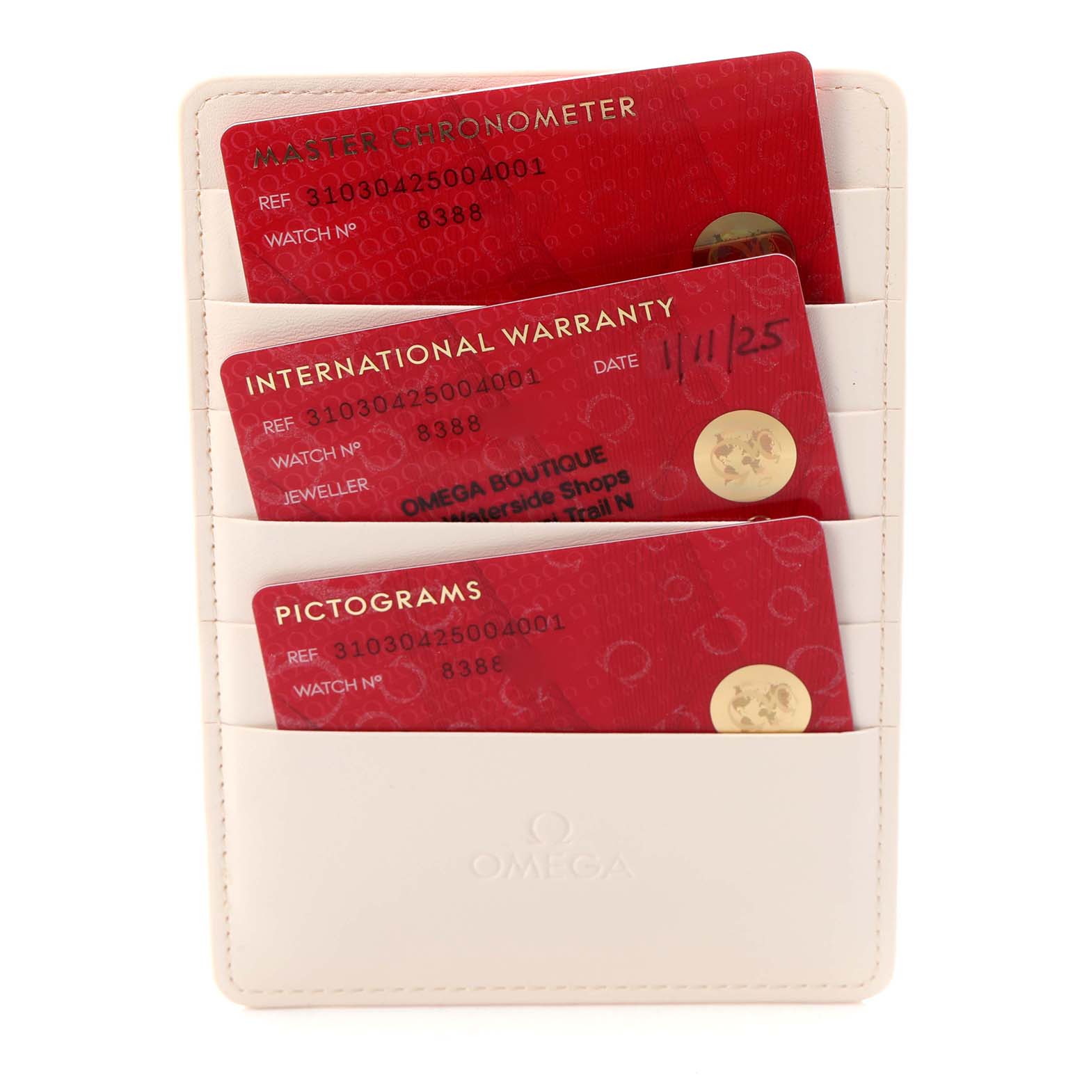 The image shows red Omega cards for the Speedmaster 310.30.42.50.04.001, including Master Chronometer, Warranty, and Pictograms, in a white cardholder.