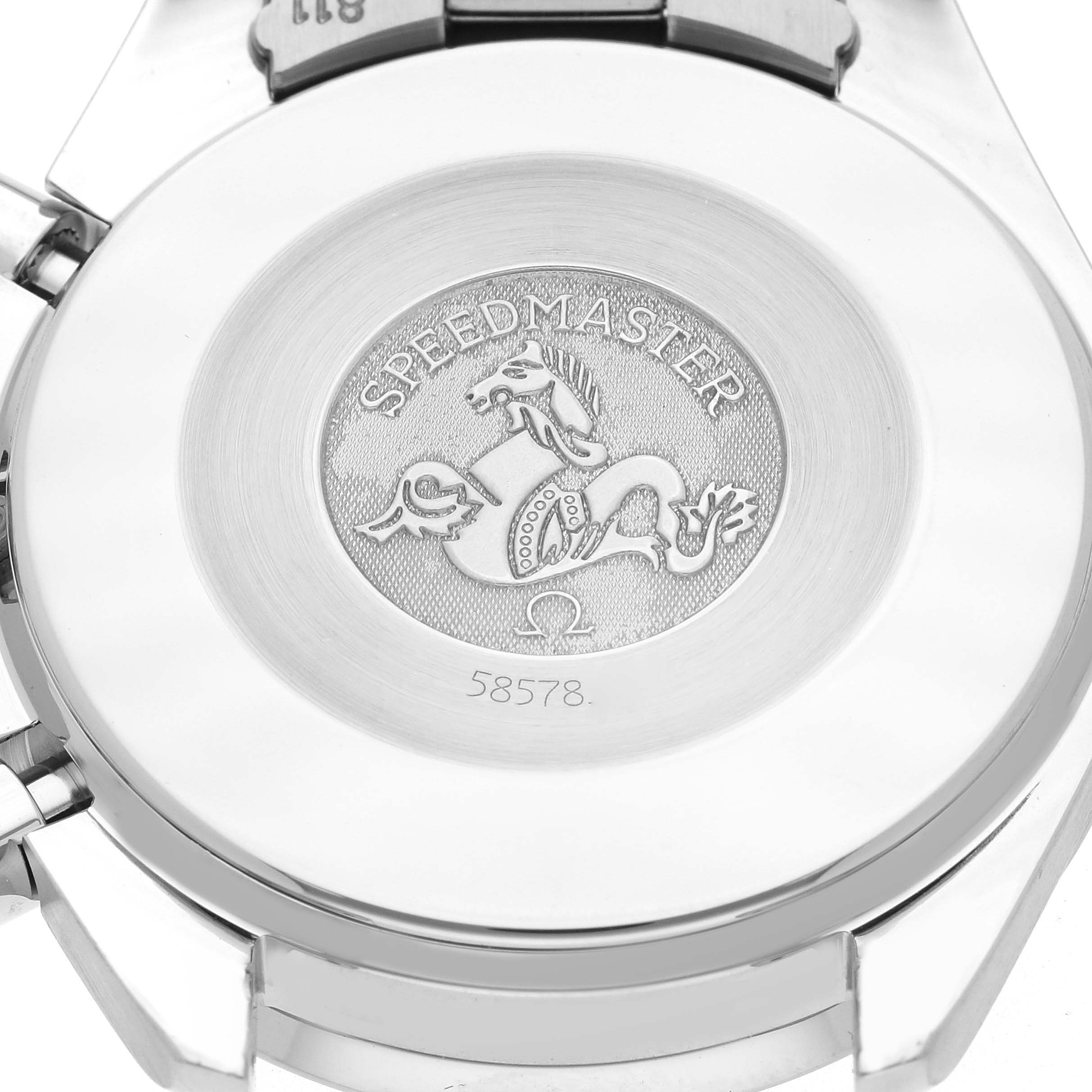 The image shows the back of the Omega Speedmaster model 3502.74.00, featuring the engraved logo and serial number.