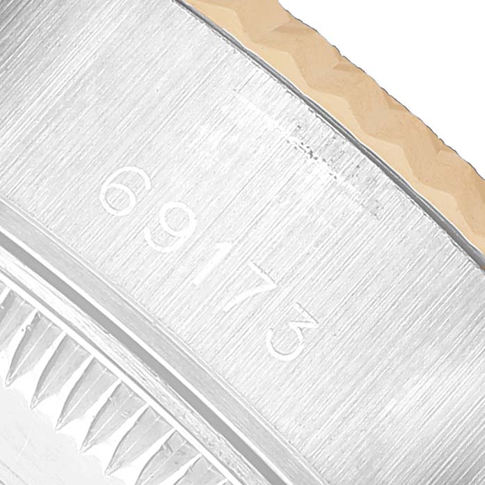 The image shows a close-up of the edge and inner bezel of a Rolex Datejust 69173 Women's Stainless Steel Grey Dial, showcasing model number engravings.