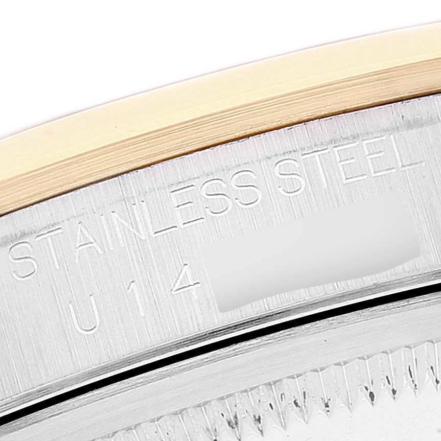 The image shows a close-up of the case back edge and serial engraving of a Rolex Datejust 16203 Men
s Steel and Gold (two tone) Grey Dial 16203 Men
s Steel and Gold (two tone) Grey Dial watch.