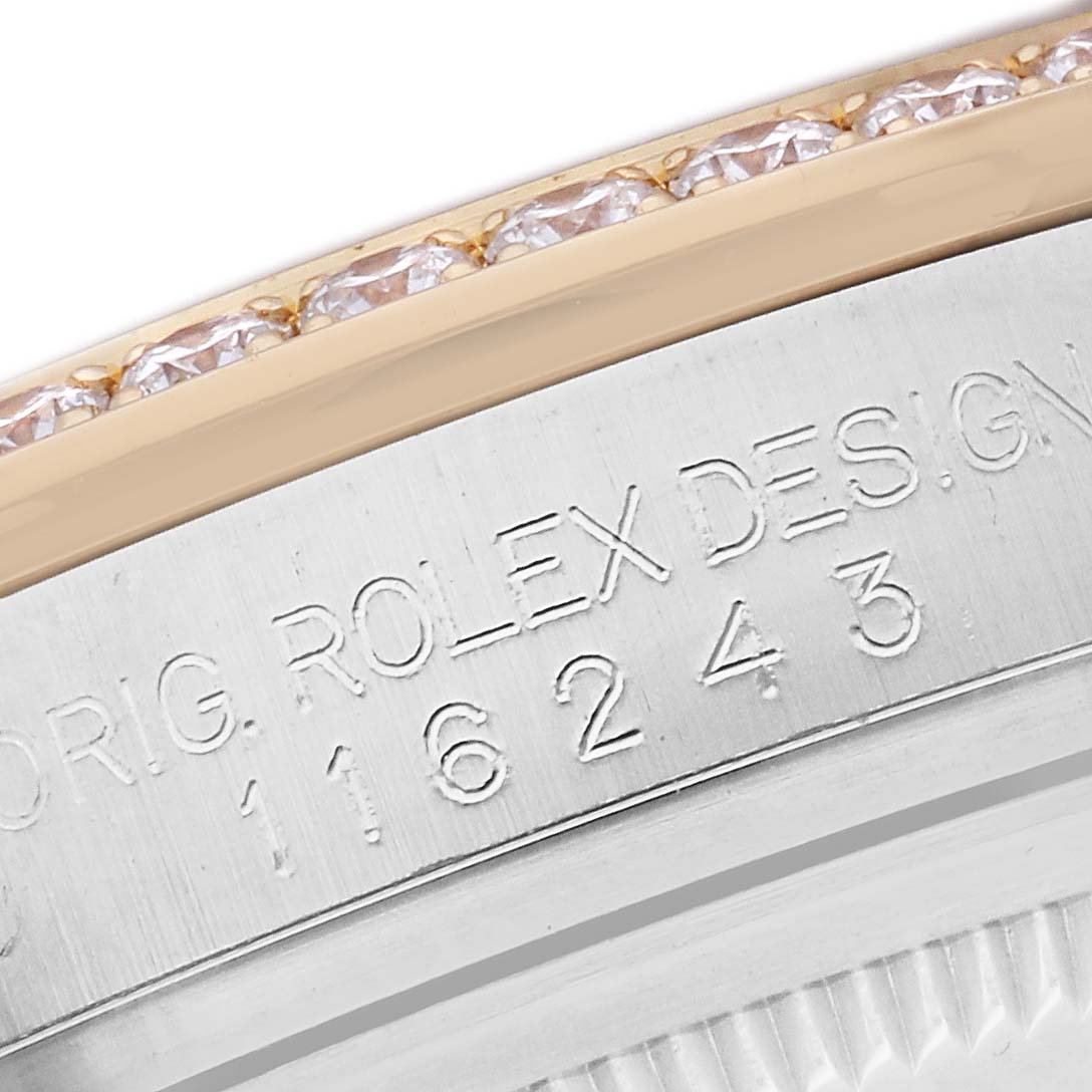 The image shows a close-up angle of the bezel with diamonds and part of the case, featuring the engraving of the Rolex Datejust model number 116243.