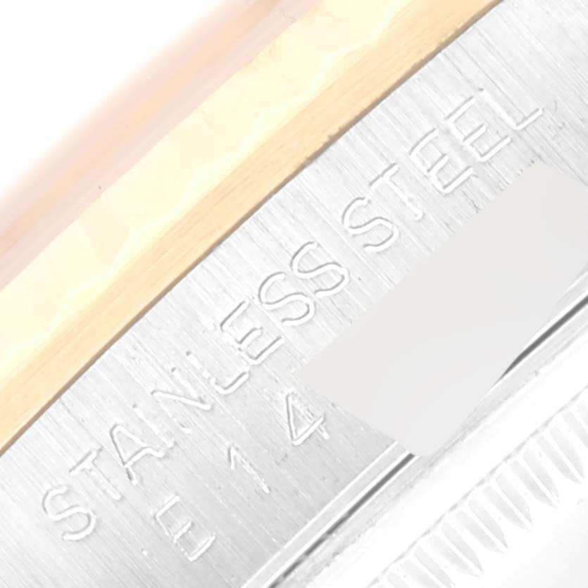 This close-up image shows the side of a Rolex Datejust 16233 Men's Steel and Gold (two tone) Champagne Dial 16233 Men's Steel and Gold (two tone) Champagne Dial watch, highlighting its 'STAINLESS STEEL' engraving.