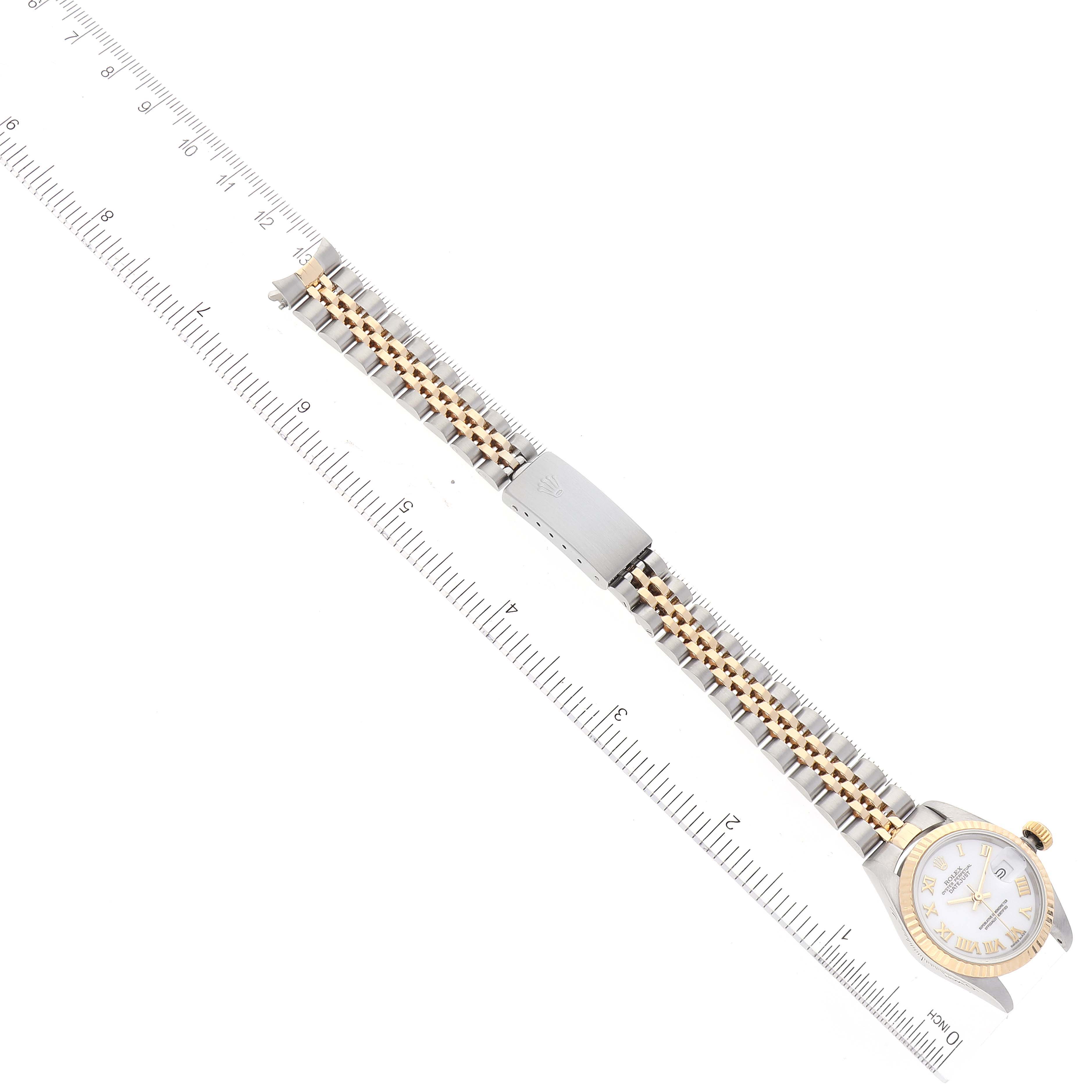 The image shows a Rolex Datejust 69173 Women
s Steel and Gold (two tone) White Dial 69173 Women
s Steel and Gold (two tone) White Dial watch laid flat and measured with a ruler, highlighting the watch face, strap, clasp, and bezel.