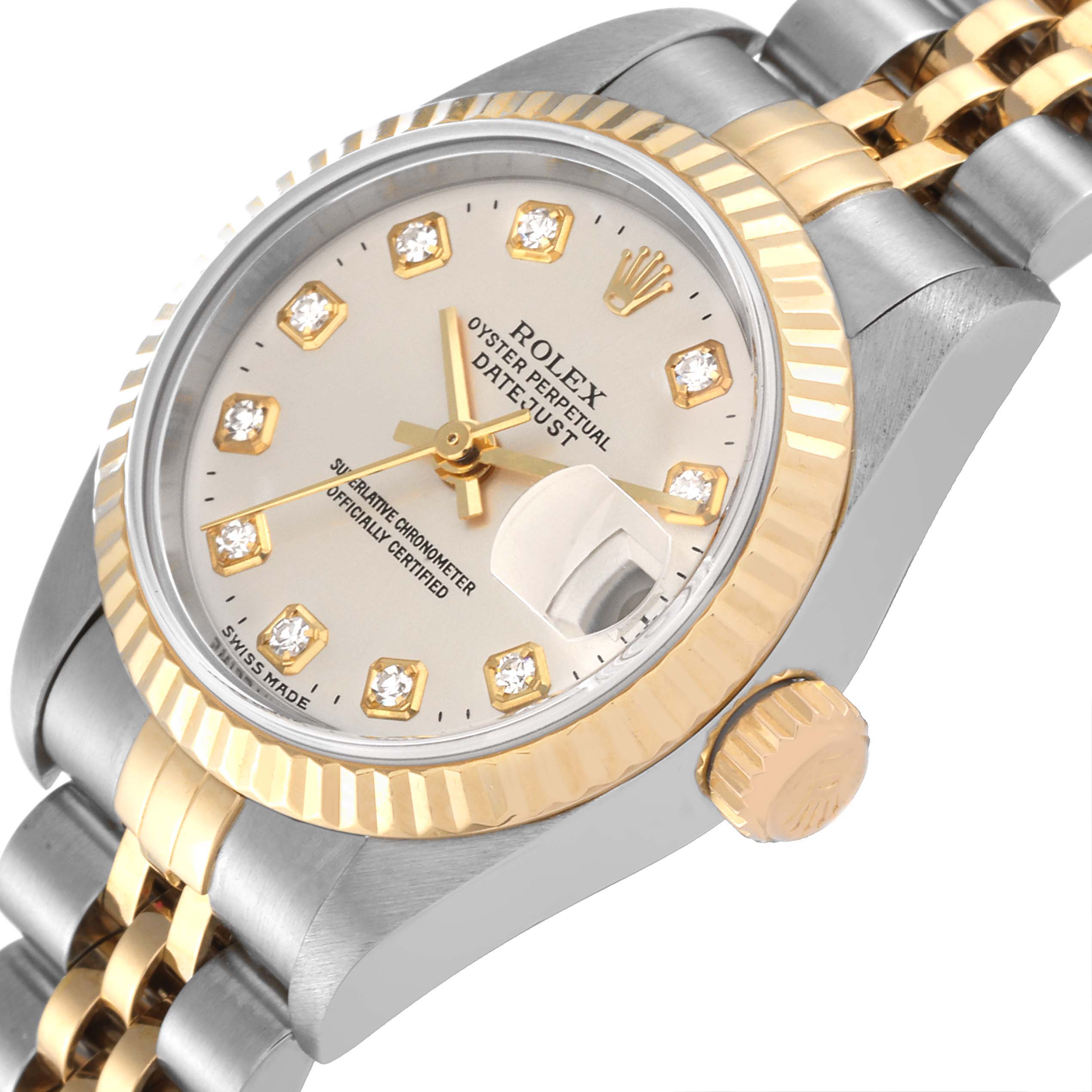 The image shows a Rolex Datejust 79173 Women
s Steel and Gold (two tone) Silver Dial 79173 Women
s Steel and Gold (two tone) Silver Dial watch
s face, crown, dial, and part of its two-tone bracelet at an angled close-up view.
