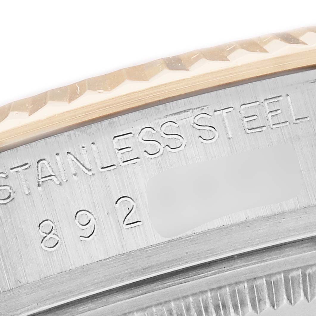 The image shows a close-up of the Rolex Datejust model 16013's fluted bezel and part of the case, highlighting the "STAINLESS STEEL" engraving.