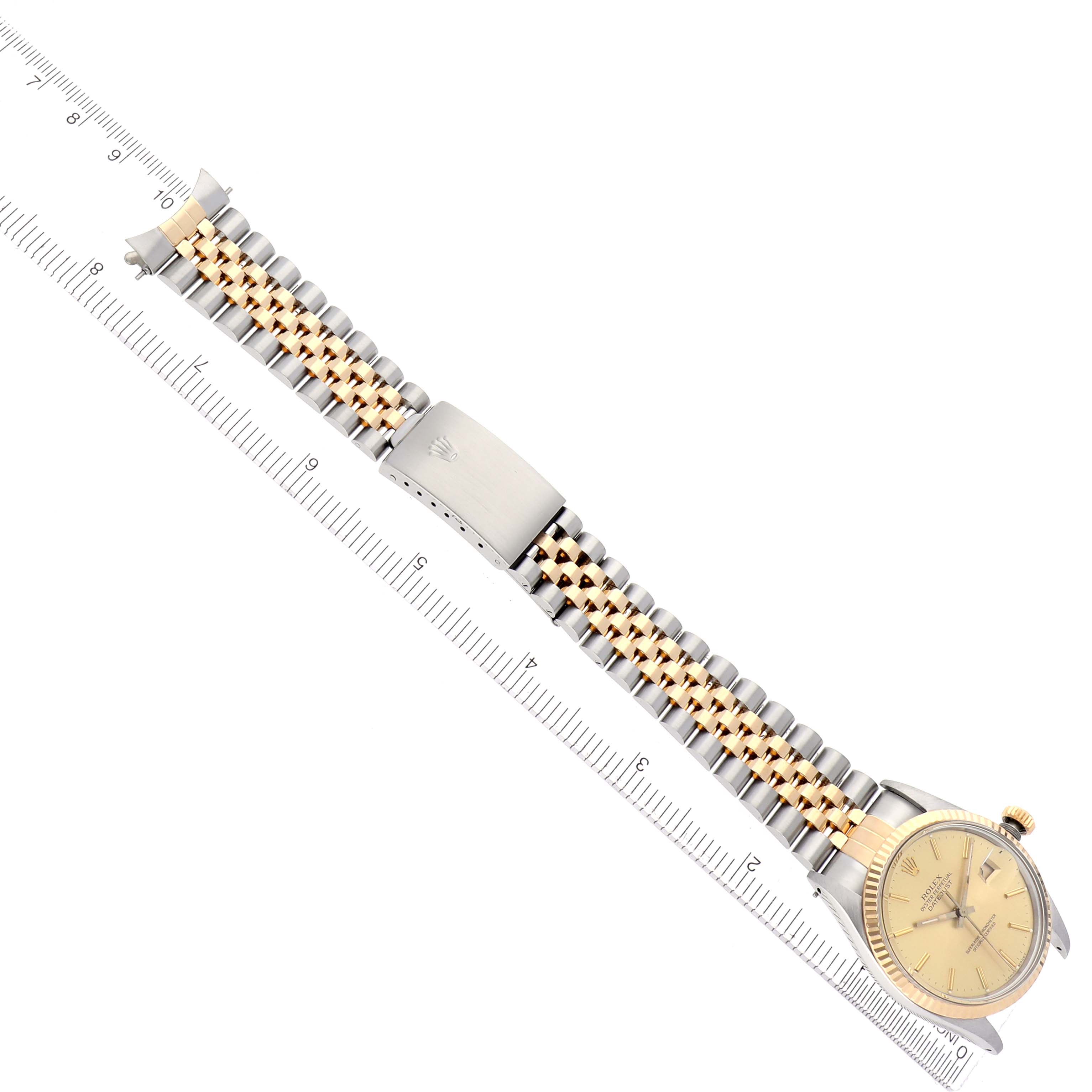 The Rolex Vintage Collection model 16013 watch is shown at a diagonal angle, displaying the watch face, bracelet, and clasp alongside a ruler for scale.