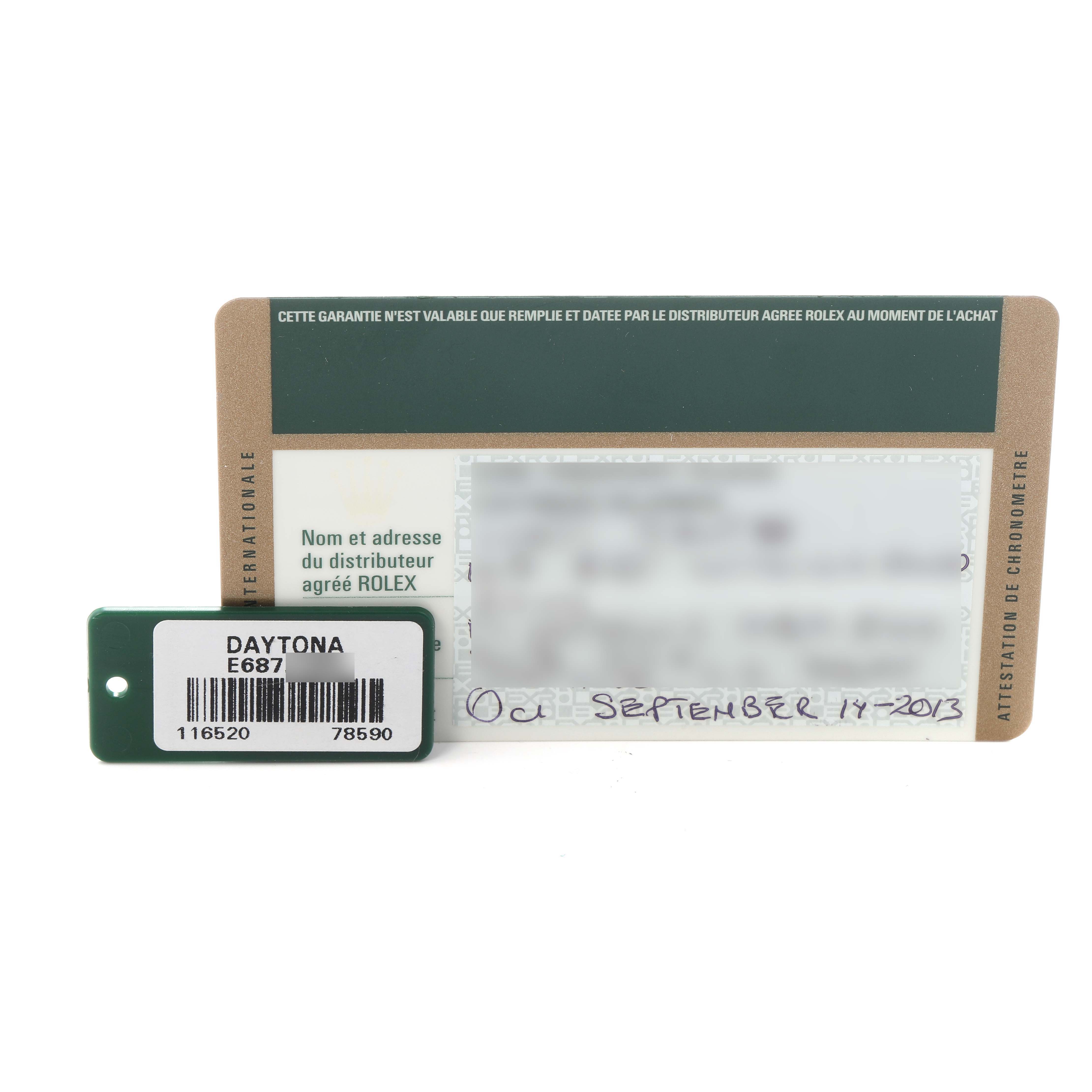 The image shows a Rolex Daytona model number 116520 men's watch warranty card and hang tag, viewed from the top.