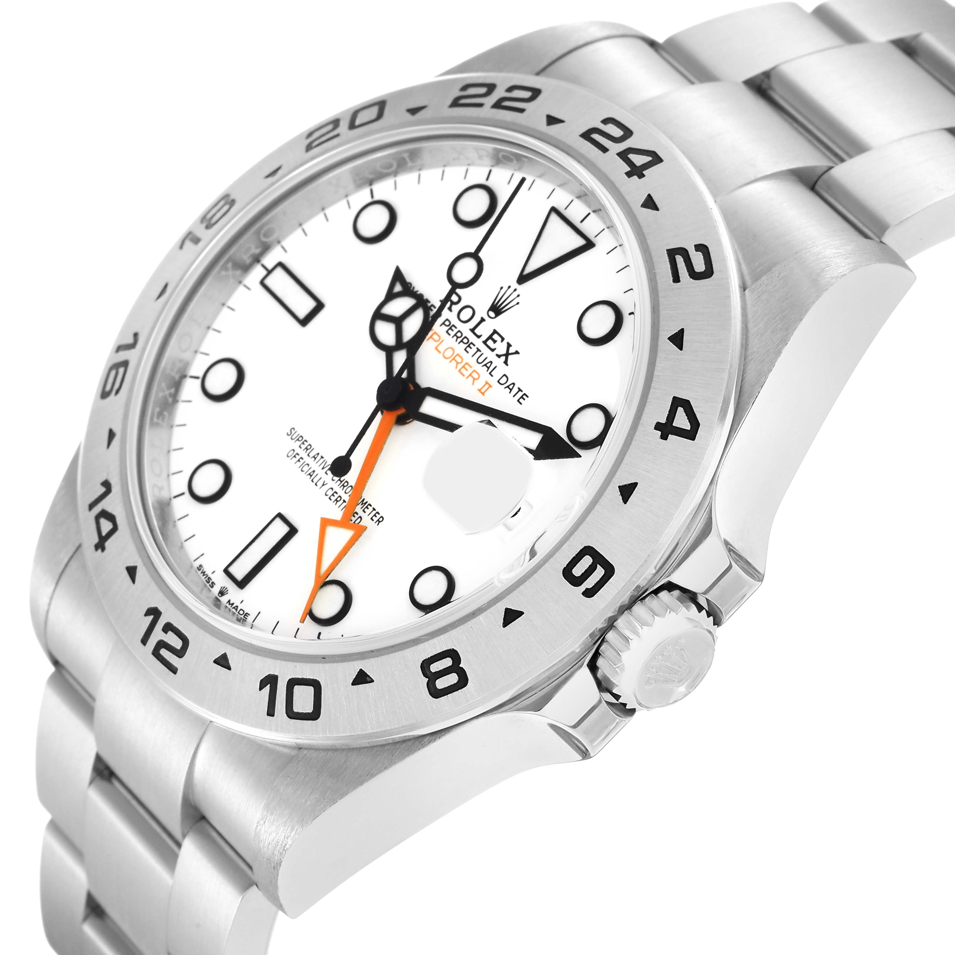 The Rolex Explorer model 226570 is shown at a slight side angle, highlighting its white dial, orange GMT hand, black hour markers, and stainless steel bracelet.