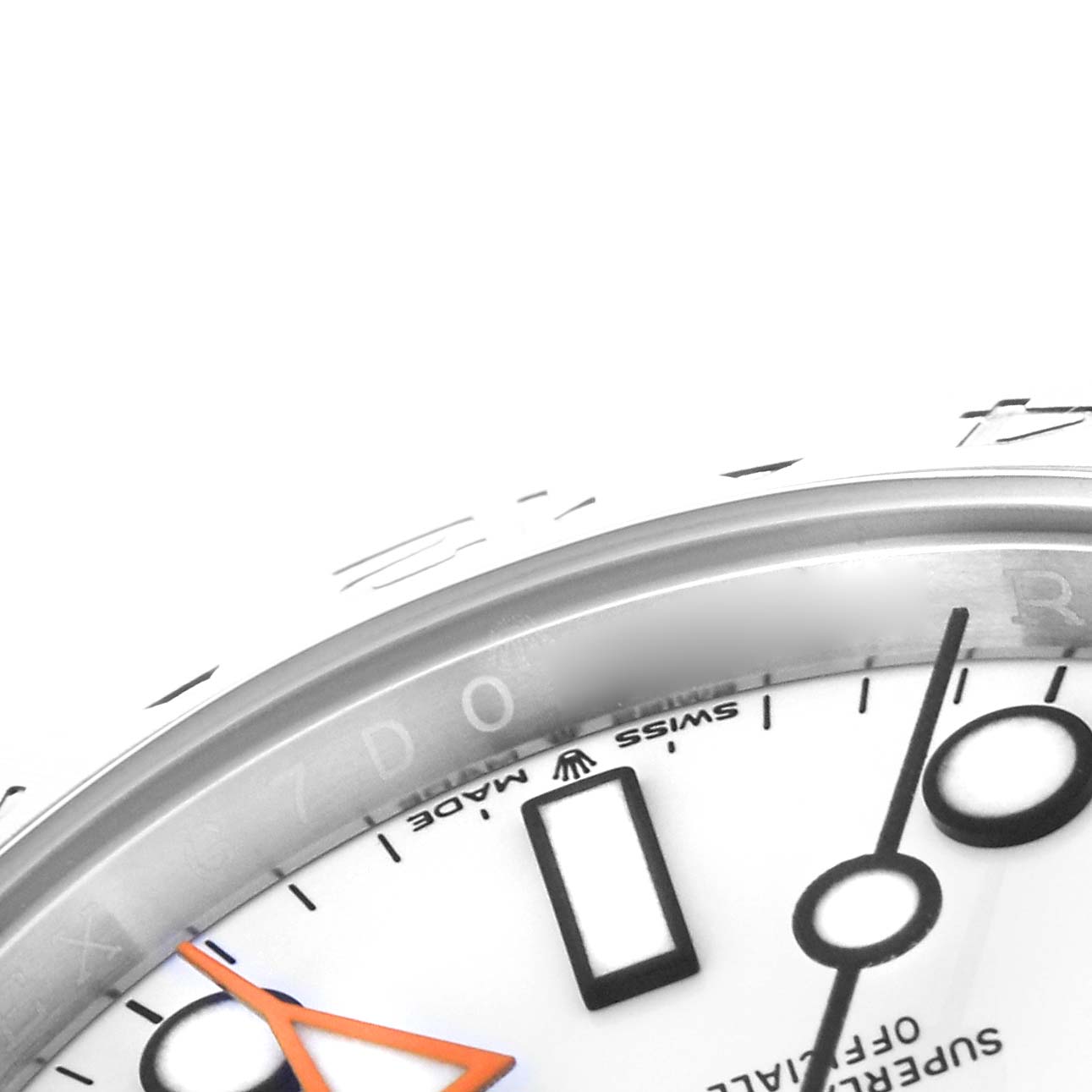 The image shows a close-up of the bezel and dial of the Rolex Explorer model 226570, highlighting the hour markers and partial text.