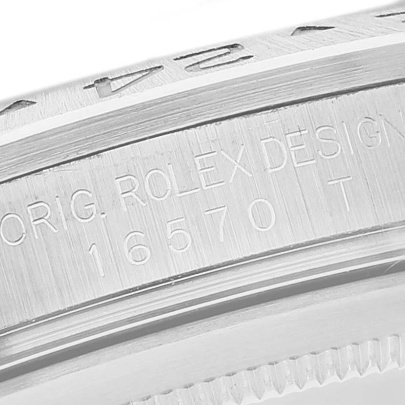 The image shows an angled close-up of the engraved bezel and case back of the Rolex Explorer 16570 Men's Stainless Steel Black Dial 16570 Men's Stainless Steel Black Dial model 16570 watch.