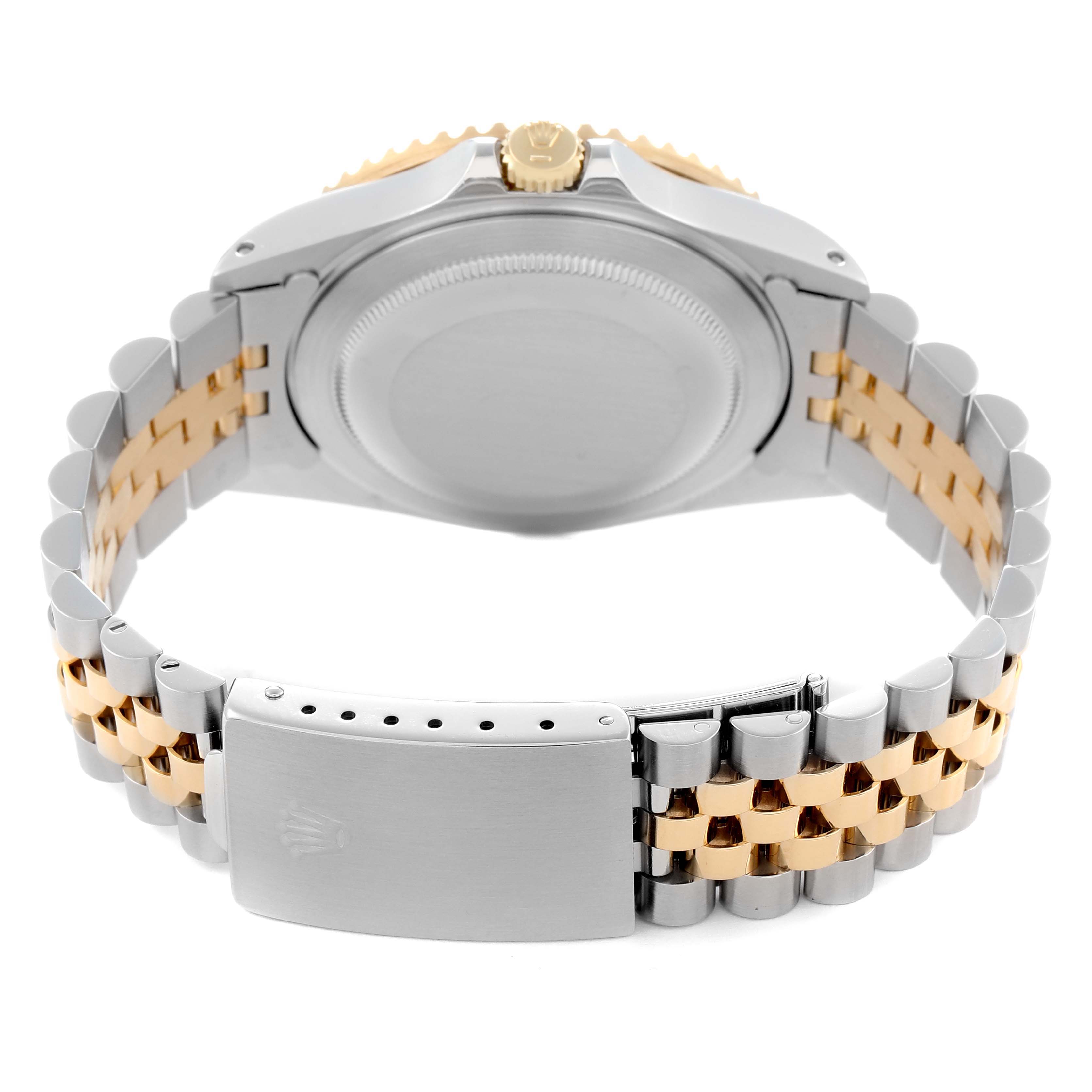 The image shows the back view of a Rolex GMT-Master model 16713 men's watch, highlighting the case back and two-tone bracelet clasp.