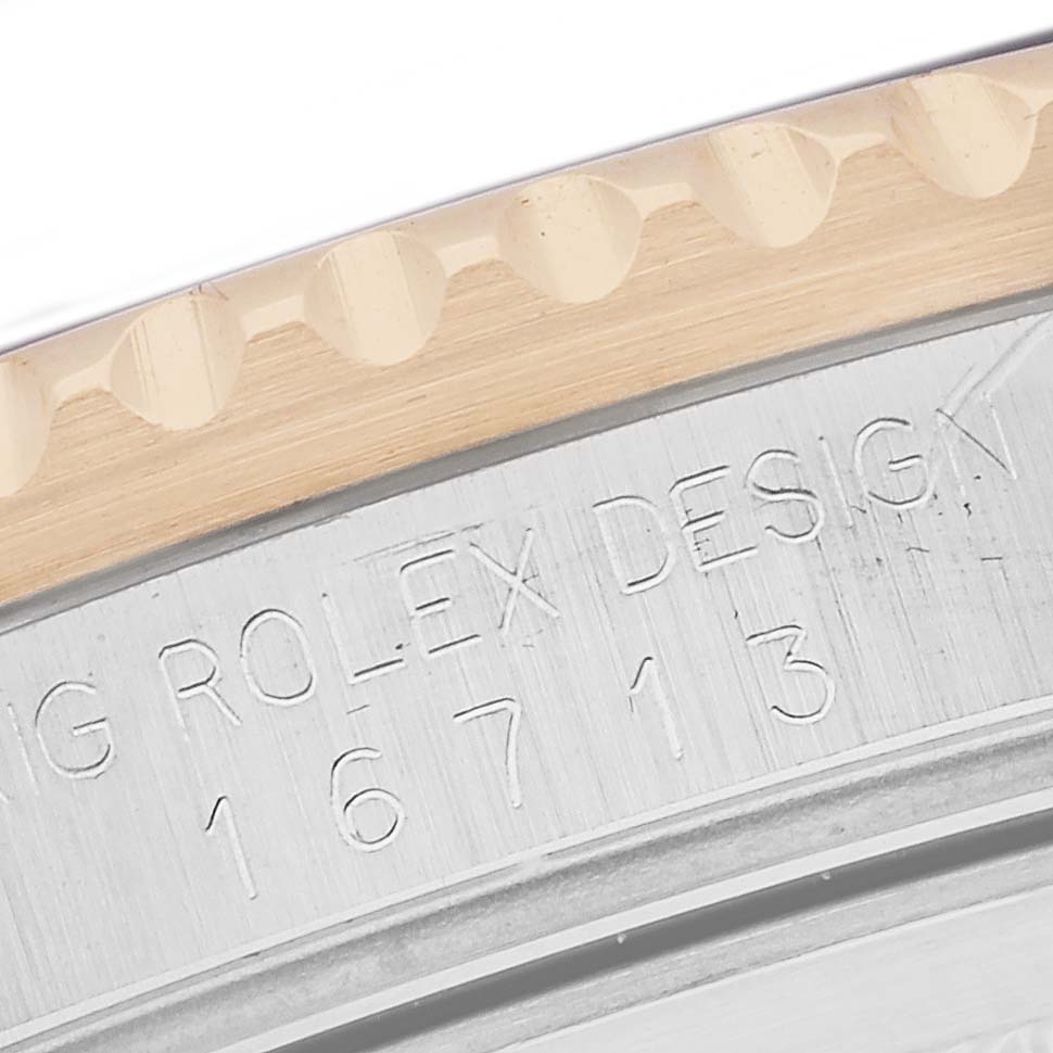 The image shows a close-up of the edge of the bezel and engraved case side of a Rolex GMT-Master model 16713.