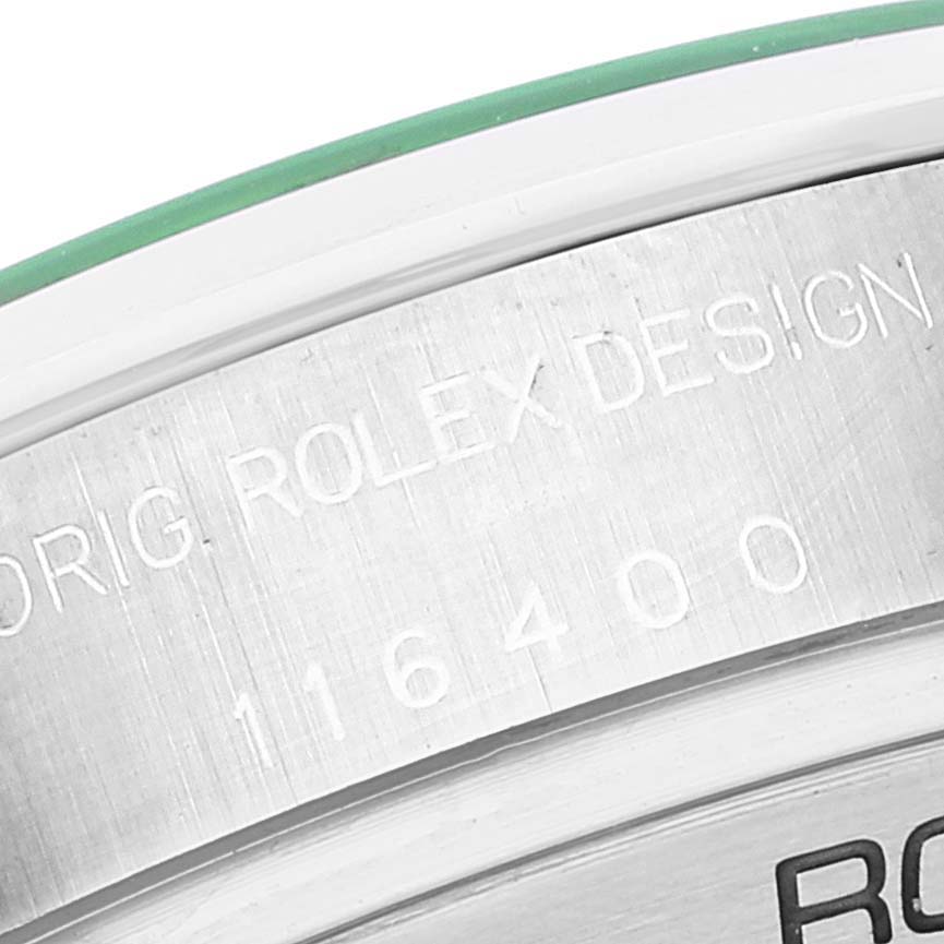 The image shows a close-up of the engraved serial number and "ORIG. ROLEX DESIGN" inscription on the case of a Rolex Milgauss 116400GV Men
s Stainless Steel Blue Dial 116400GV Men
s Stainless Steel Blue Dial watch.