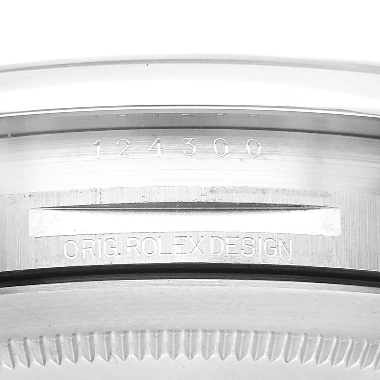 The image shows the side of a Rolex Oyster Perpetual model 124300, displaying the model number and "Orig Rolex Design" engraving.