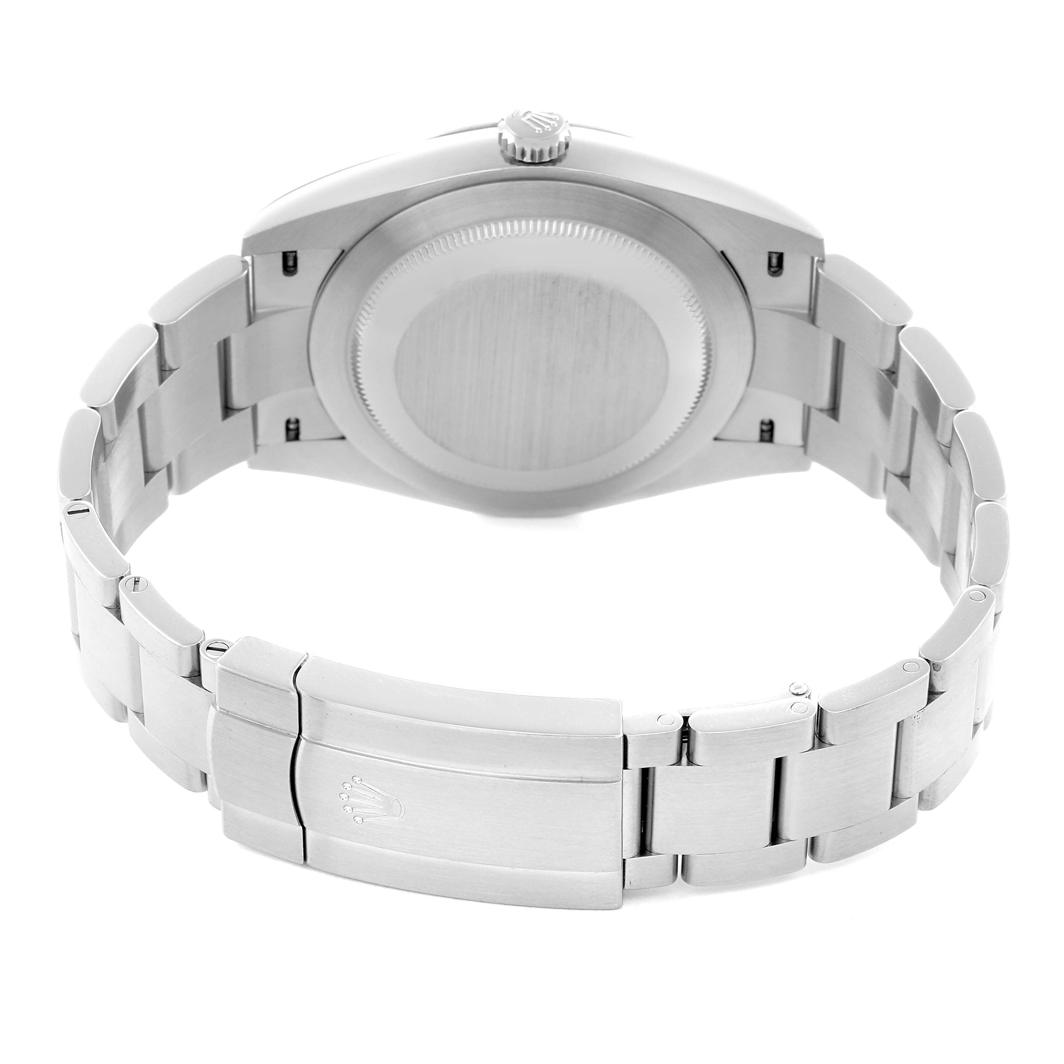 The image shows the back view of a Rolex Oyster Perpetual model 124300 men's watch, highlighting the case back and stainless steel bracelet with the clasp.