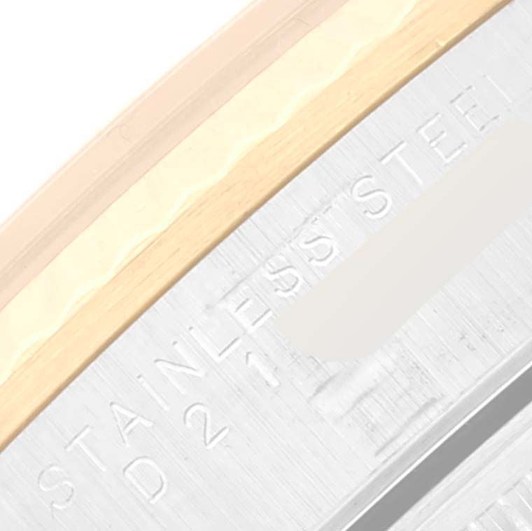 This image shows a close-up of the bezel and casing of a Rolex Oyster Perpetual 14233 Men's Steel and Gold (two tone) Champagne Dial 14233 Men's Steel and Gold (two tone) Champagne Dial watch, highlighting the "Stainless Steel" engraving.