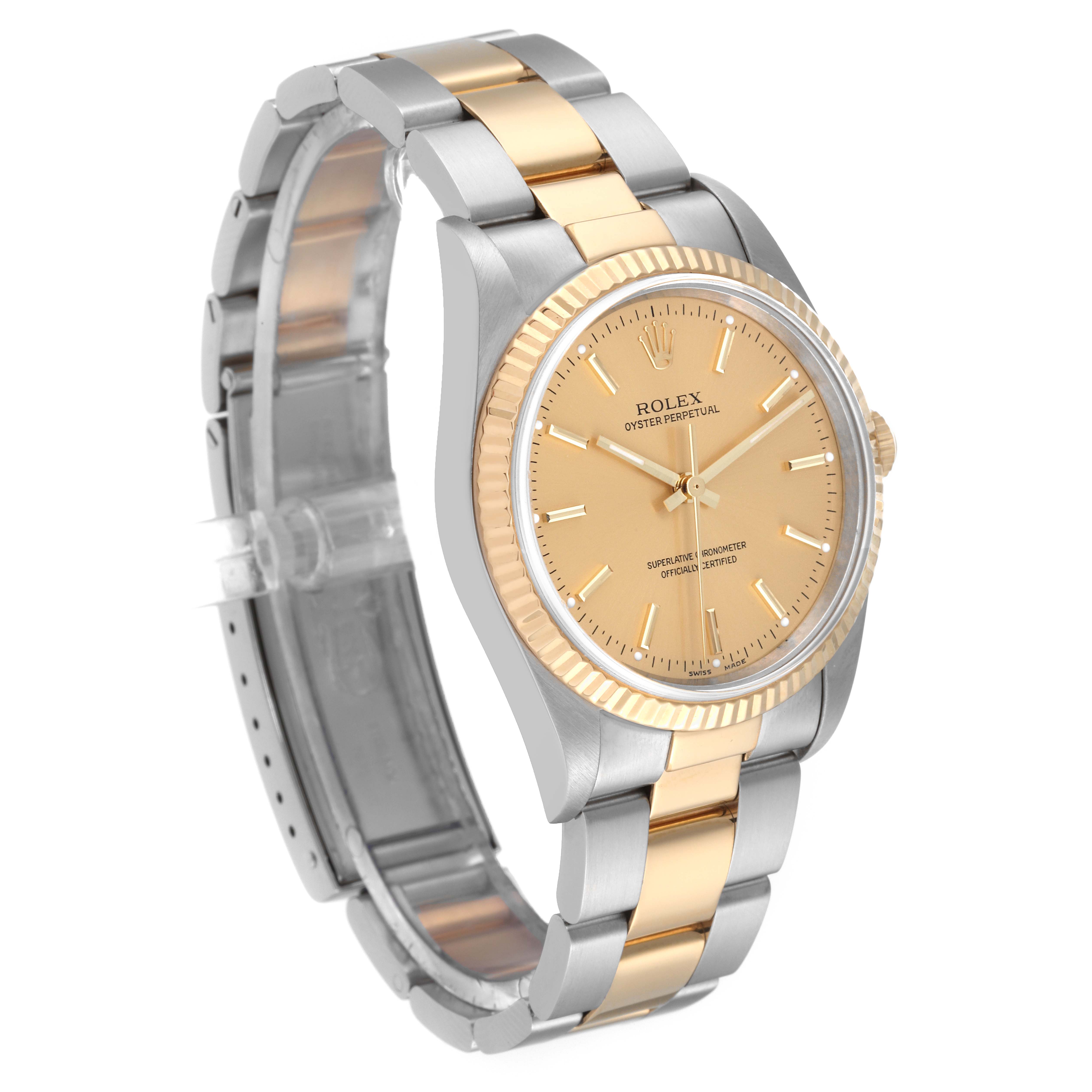 The Rolex Oyster Perpetual 14233 Men's Steel and Gold (two tone) Champagne Dial 14233 Men's Steel and Gold (two tone) Champagne Dial watch is shown at an angle, displaying its two-tone band, fluted bezel, and champagne dial.