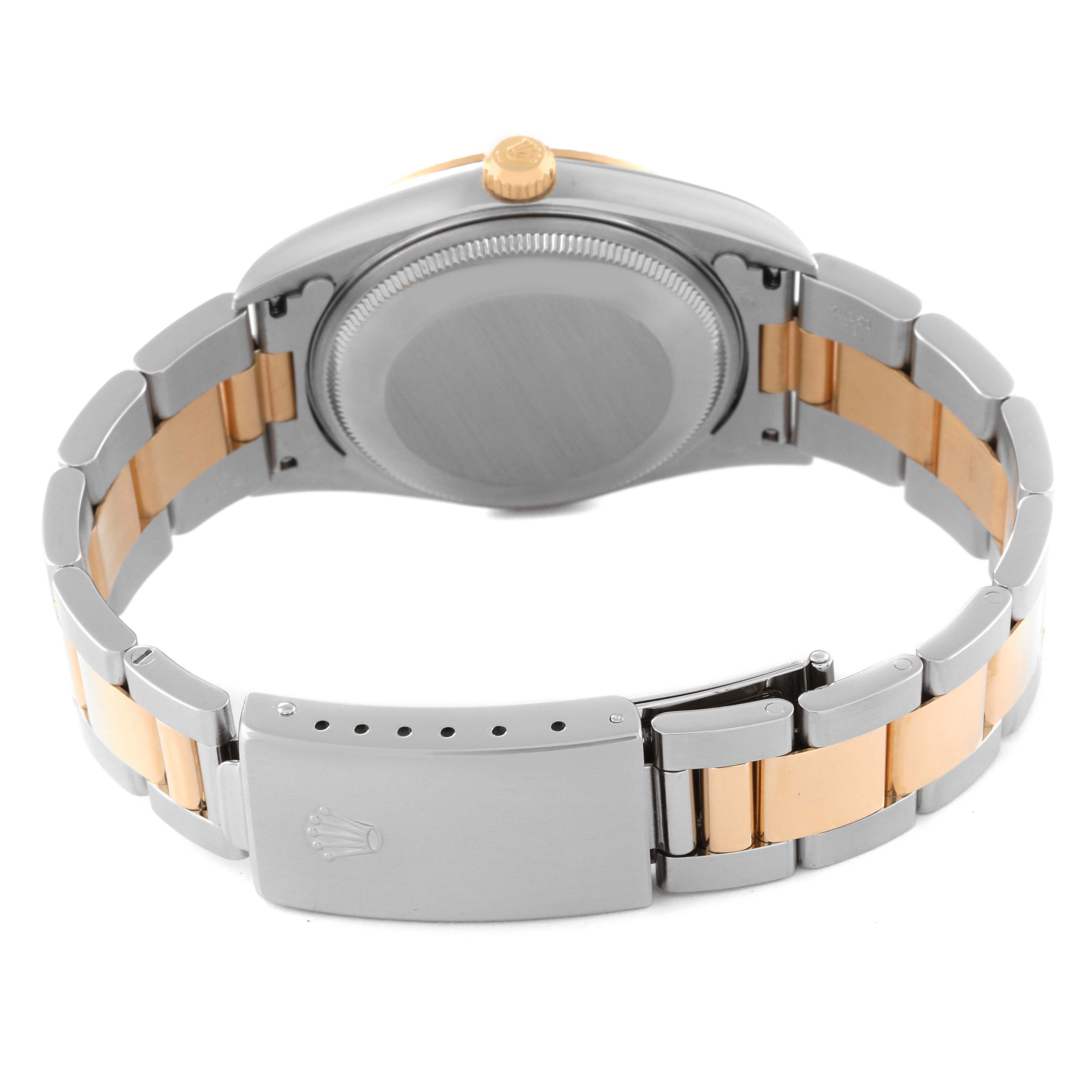 The image shows the back and clasp of a Rolex Oyster Perpetual 14233 Men's Steel and Gold (two tone) Champagne Dial 14233 Men's Steel and Gold (two tone) Champagne Dial watch, highlighting the two-tone bracelet.