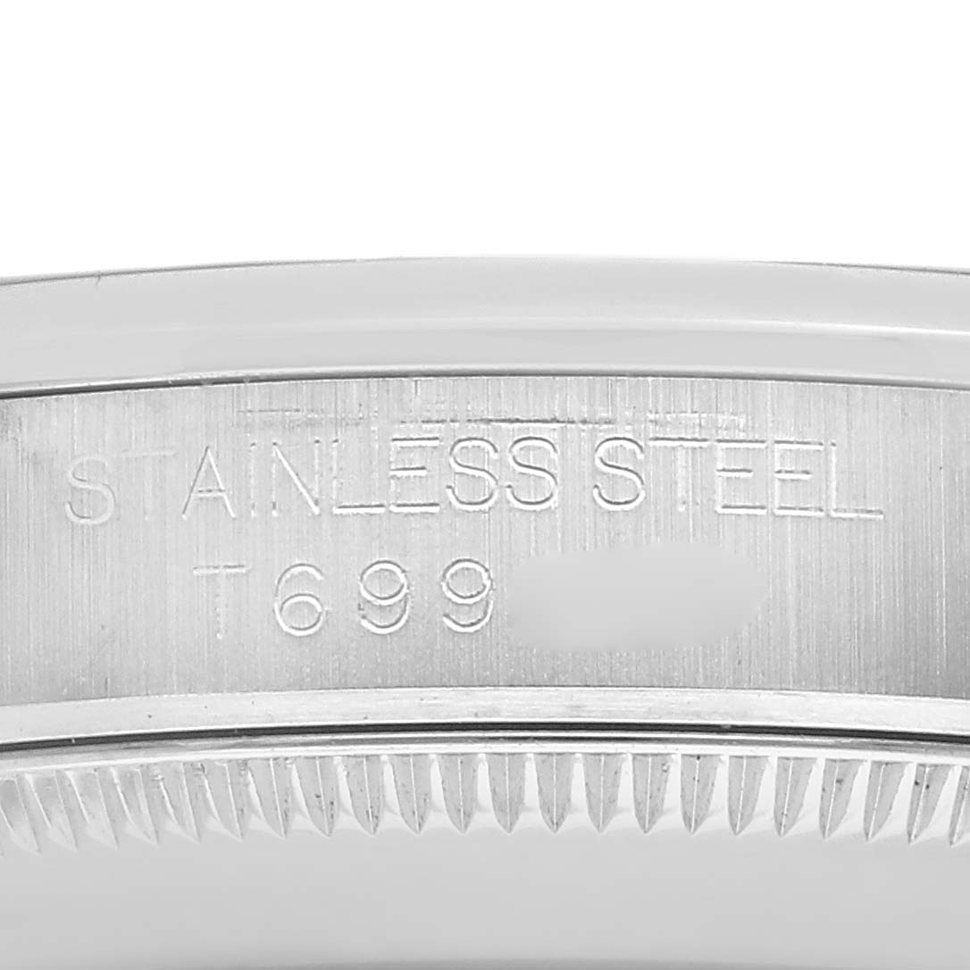 The image shows a close-up of the side of a Rolex Oyster Perpetual model 67480, focusing on the engraved stainless steel part of the watch case.