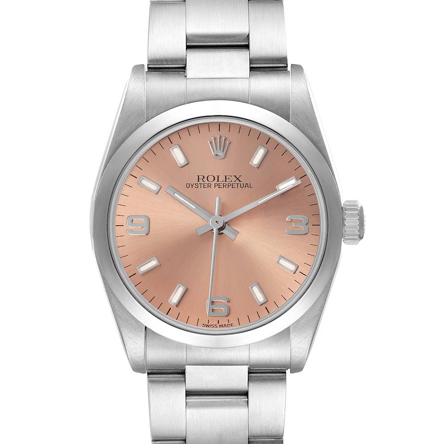 The Rolex Oyster Perpetual model 67480 watch is shown from a front view, highlighting its salmon dial, stainless steel bezel, and bracelet.