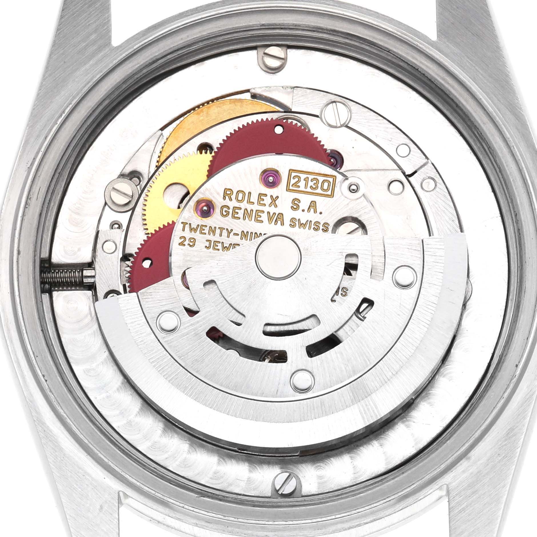 The image shows the movement mechanism of a Rolex Oyster Perpetual model 67480, highlighting gears and the rotor from a top-down angle.