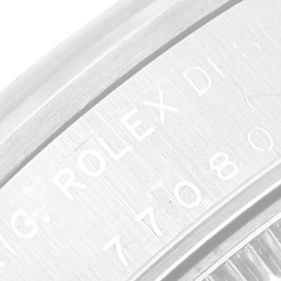 This close-up image of the Rolex Mid-Size 77080 Women's Stainless Steel Pink Dial 77080 Women's Stainless Steel Pink Dial model shows the engraved details on the watch's bezel.
