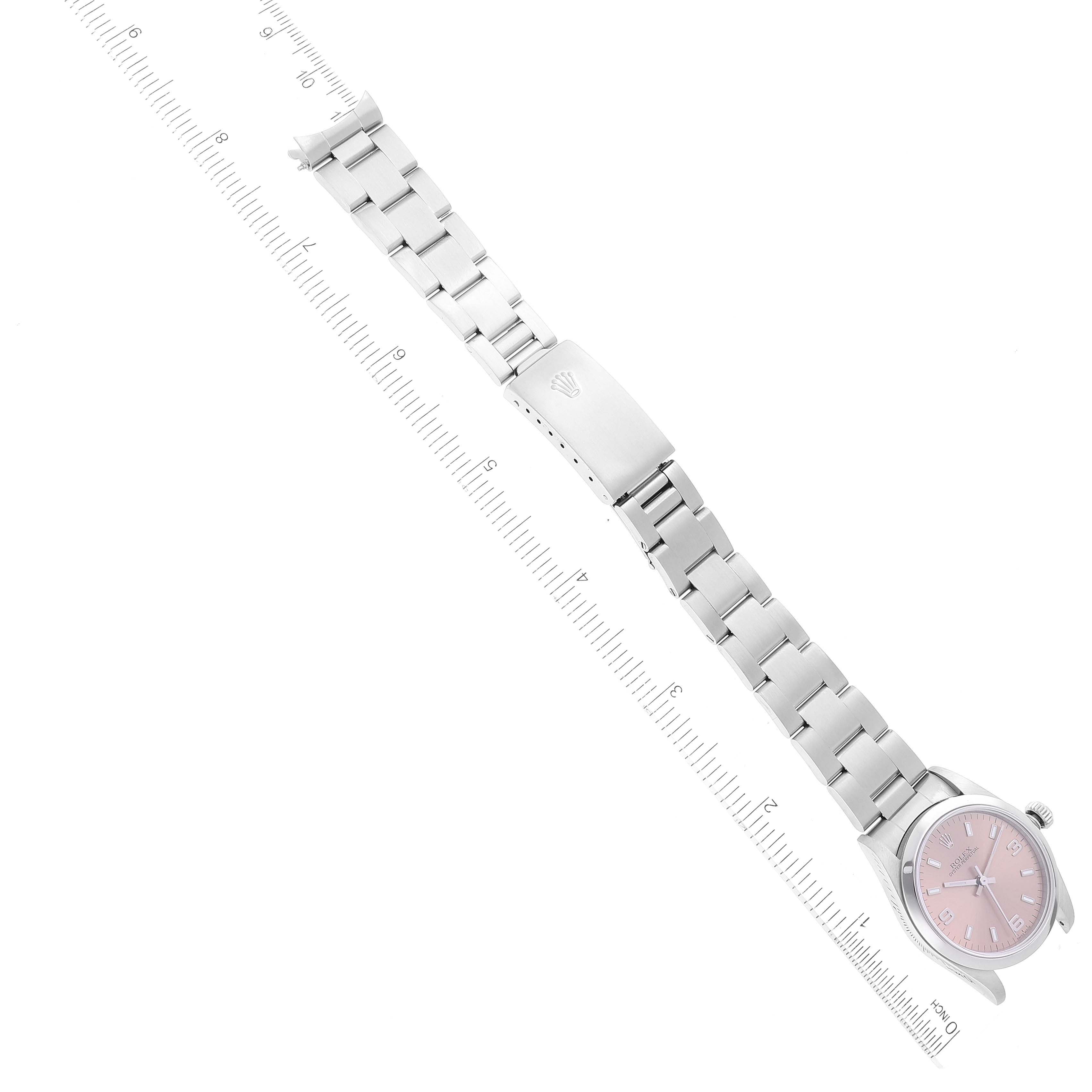 This Rolex Mid-Size 77080 Women's Stainless Steel Pink Dial 77080 Women's Stainless Steel Pink Dial watch is shown from a top-down angle, displaying its pink dial, stainless steel bracelet, and clasp.