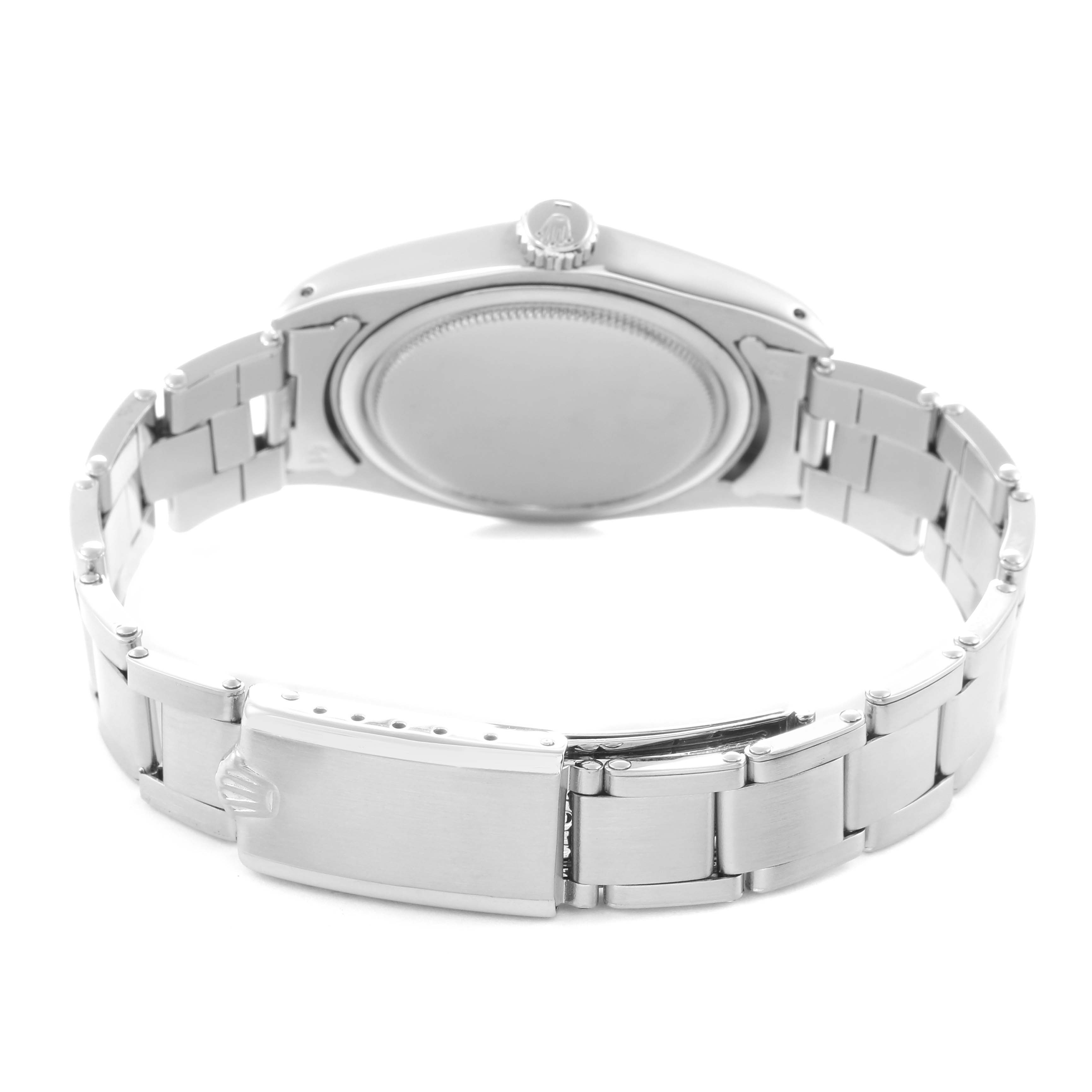 The image shows the back view of a Rolex Date Model 6694 men
s watch, highlighting the case back, crown, and stainless steel bracelet with a clasp.