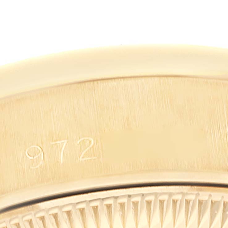 The image shows a close-up of the case back
s edge and serial number of a Rolex President 69158 Women
s Yellow Gold Champagne Dial 69158 Women
s Yellow Gold Champagne Dial model watch.