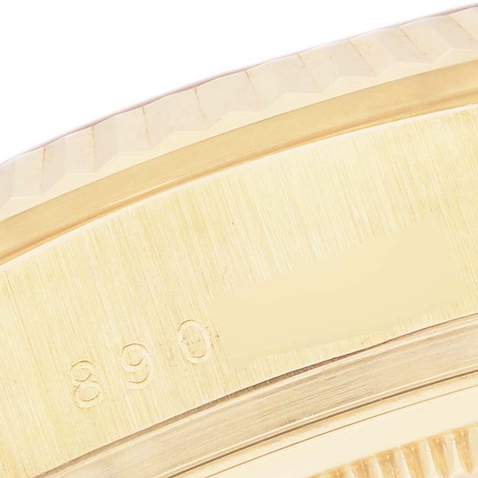 This close-up image shows the side of a Rolex President 18038 Men
s Yellow Gold Champagne Dial 18038 Men
s Yellow Gold Champagne Dial watch, focusing on the bezel and engraved serial number.