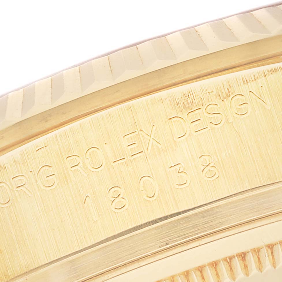 The image shows a close-up of the side of the bezel and case, featuring engravings of the Rolex President 18038 Men
s Yellow Gold Champagne Dial 18038 Men
s Yellow Gold Champagne Dial model.